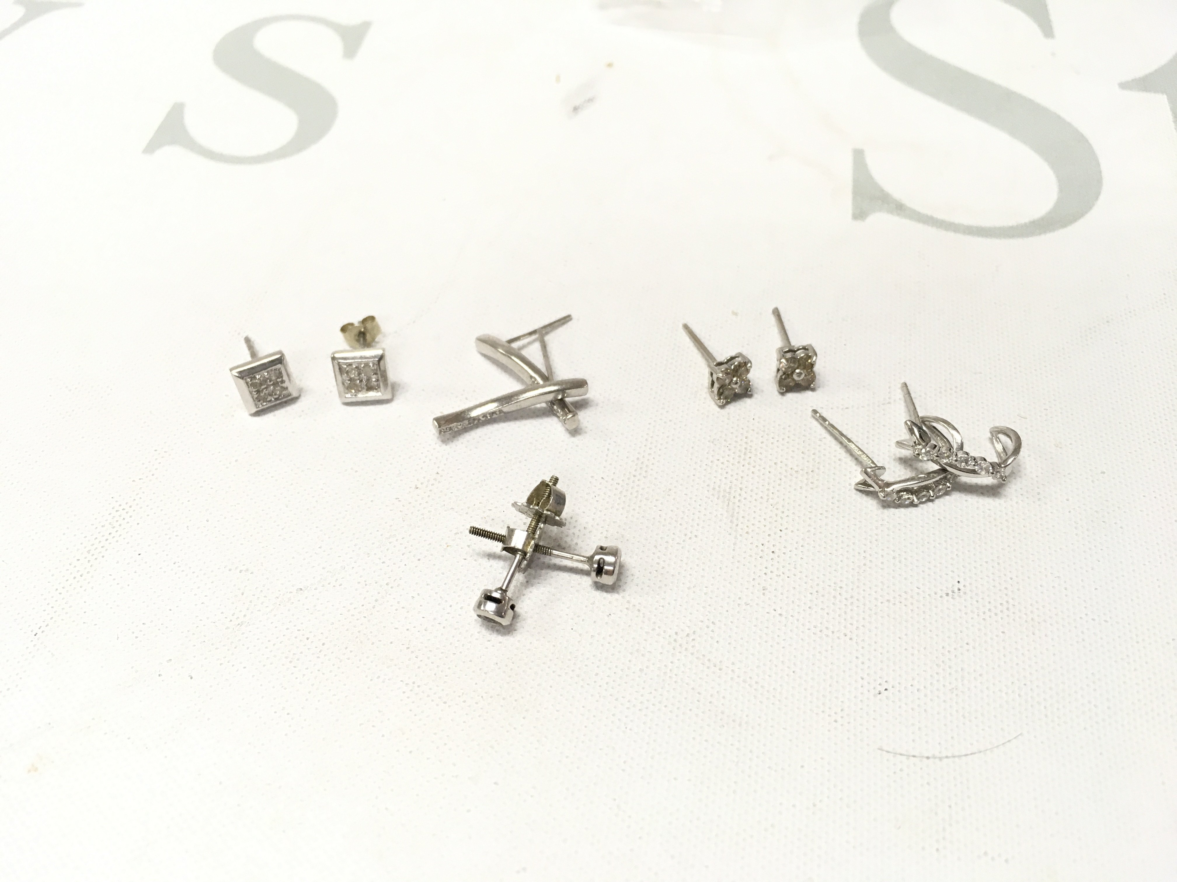 Five pairs of 9ct white gold stone set studs. Approx weight 5.1 grams.