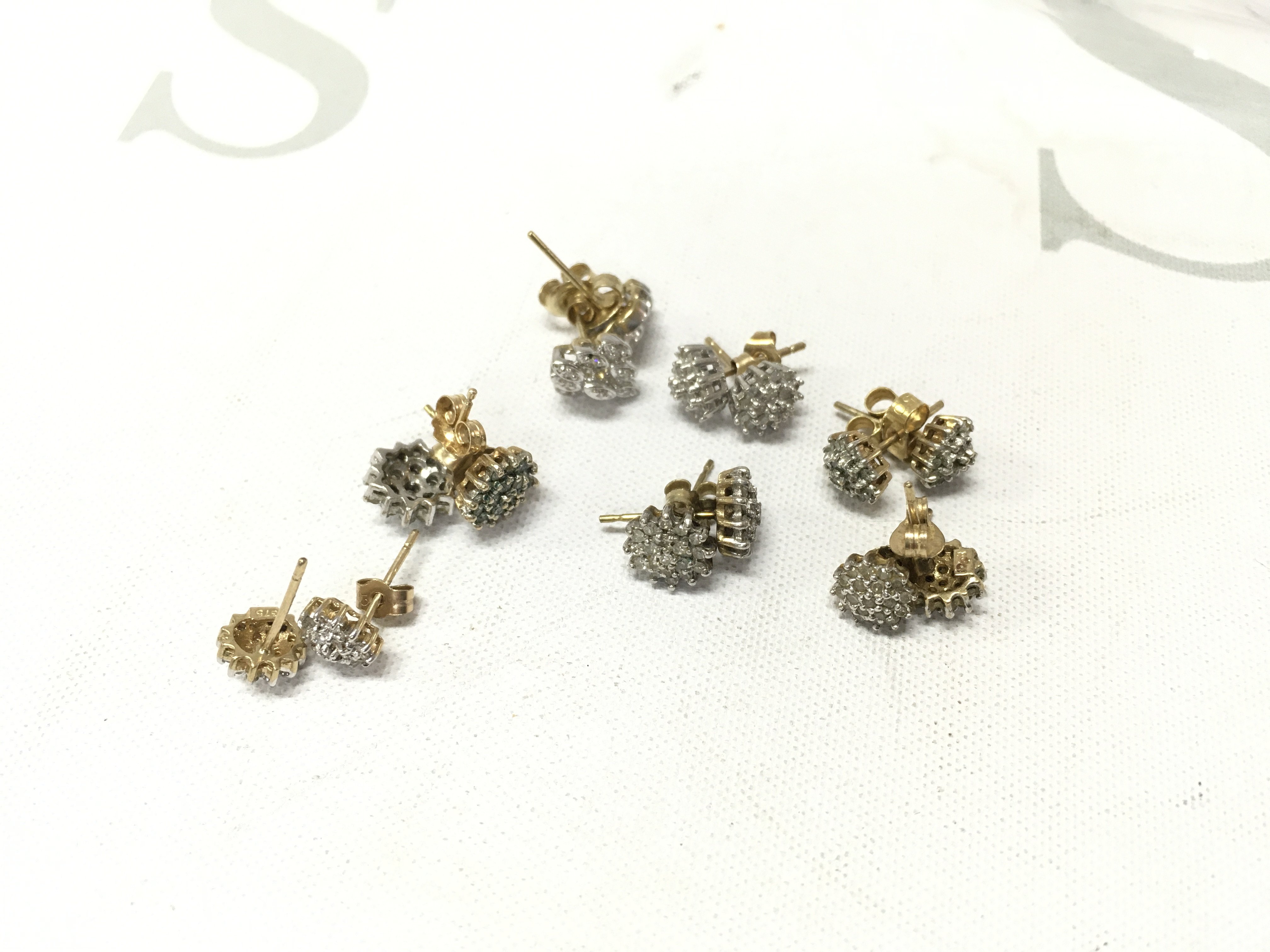 Seven pairs of 9ct gold cluster studs. Approx weight 9grams.