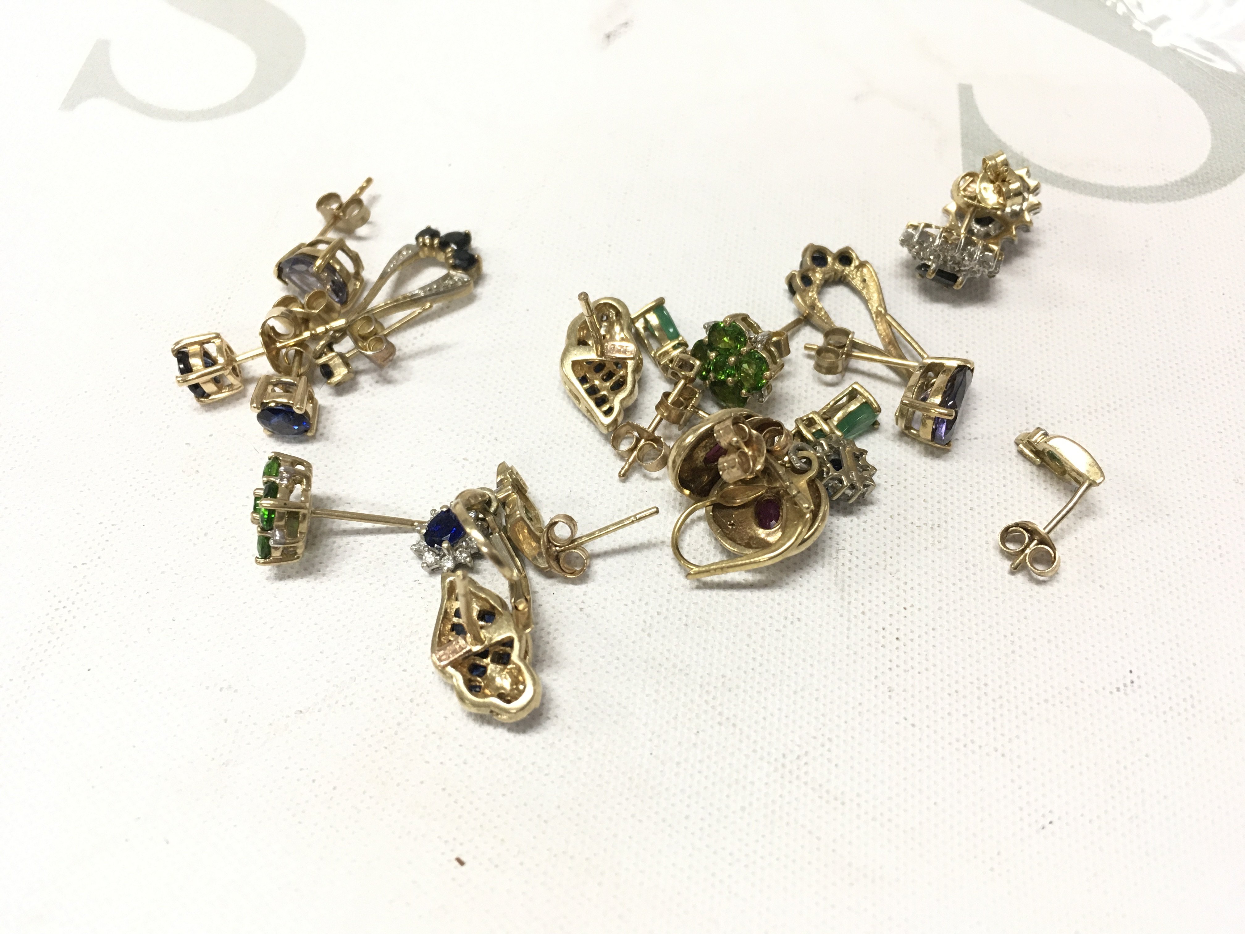 A mixed assortment of 9ct gold stone set studs. Approx weight 17.2grams.