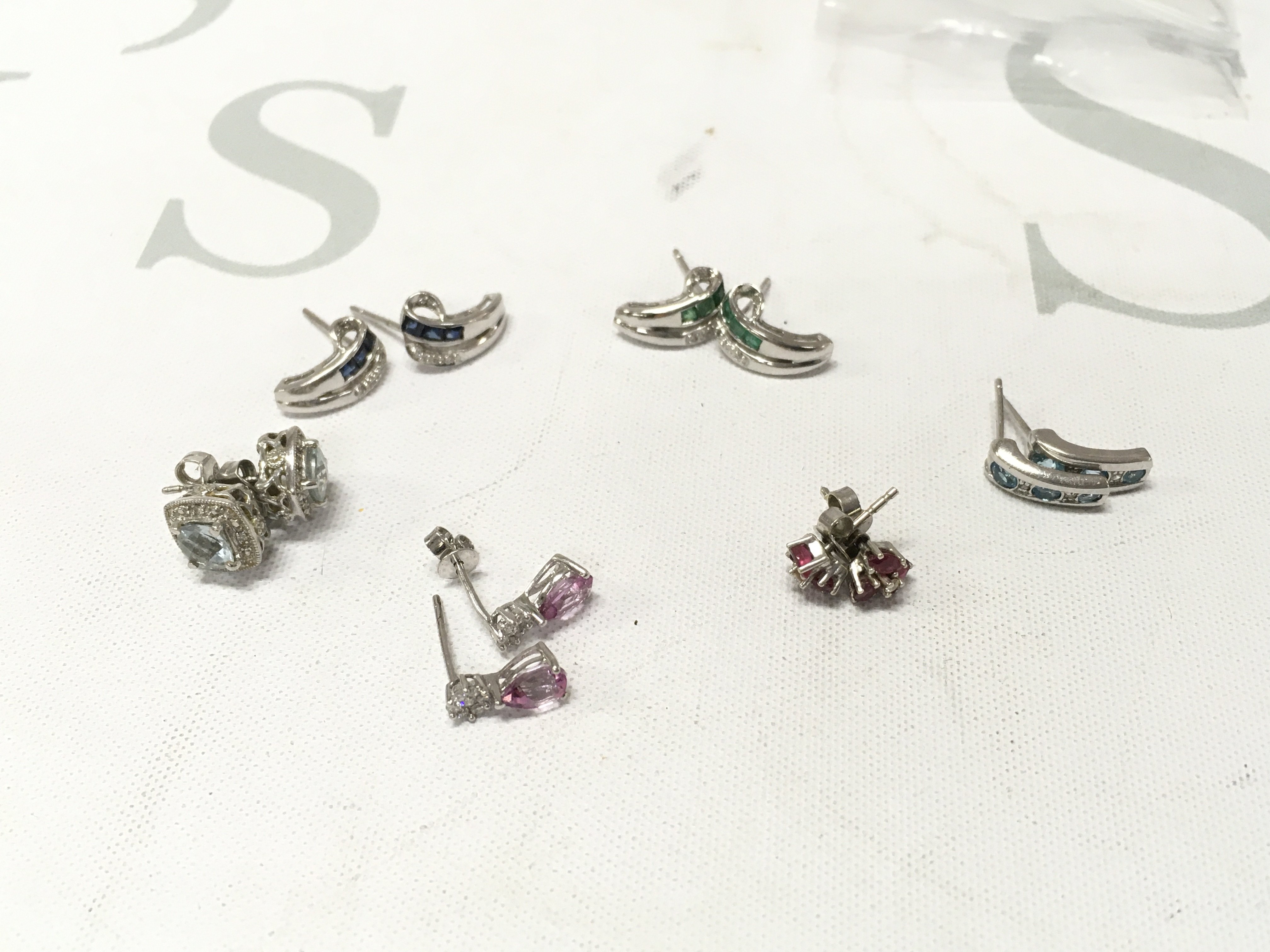 Six pairs of 9ct white gold stone set studs. Approx weight 9.6 grams.