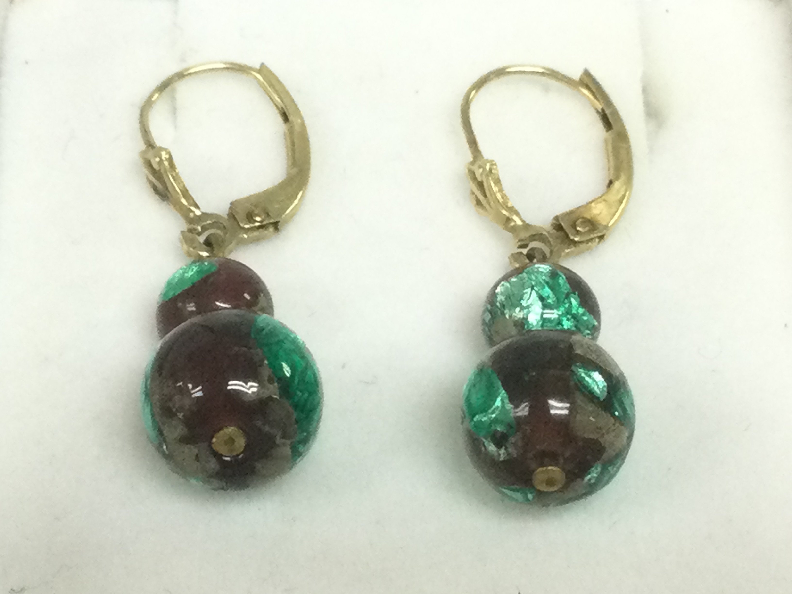 A pair of drop earrings with 14k gold clasps. Shipping category A.