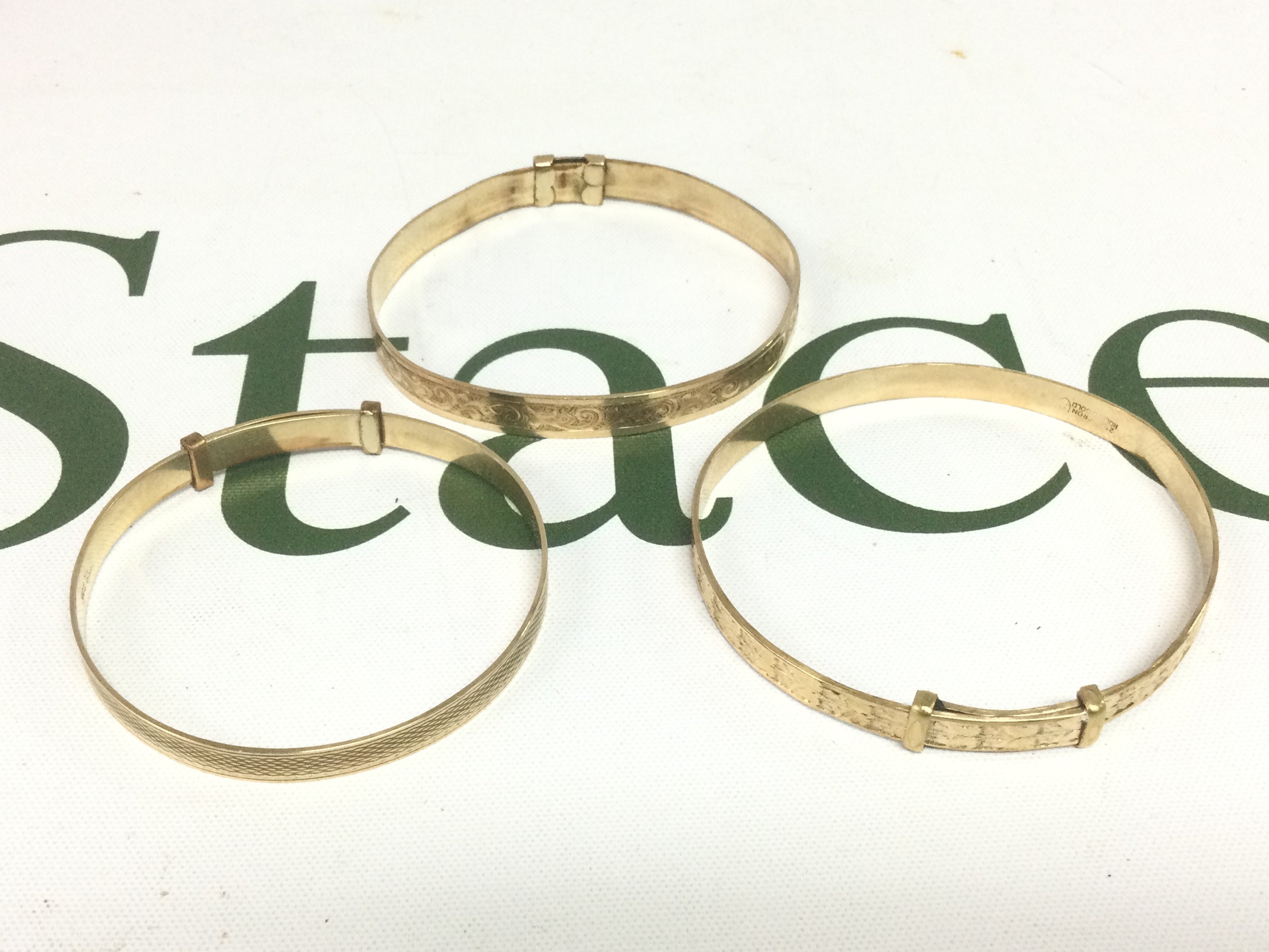 A 9ct gold bracelet with a metal core and two rolled gold bracelets (3). Shipping category A.