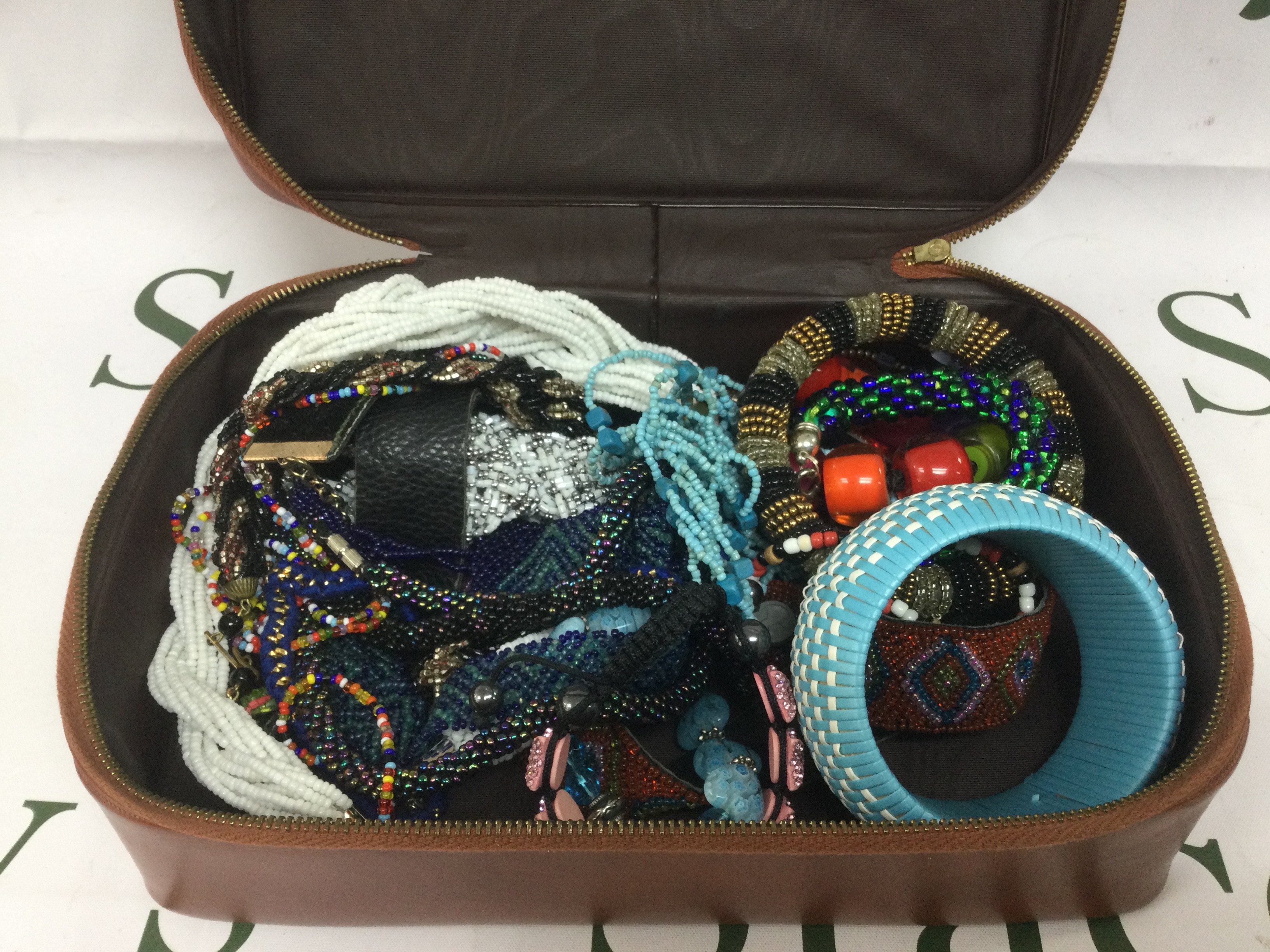 A collection of beaded necklaces and bracelets. Shipping category B.