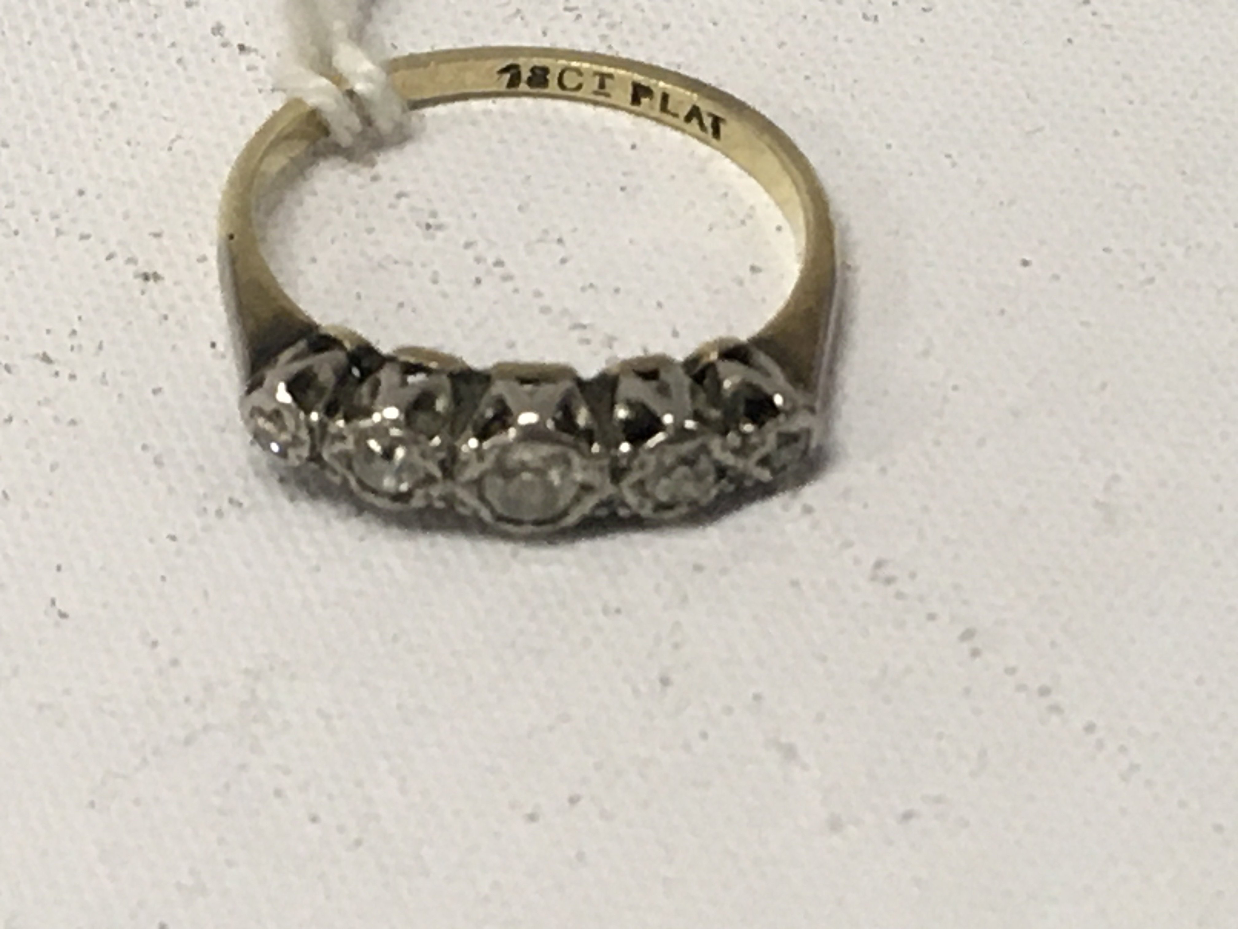 A 18 ct gold ring inset with five diamond chips . Size O .