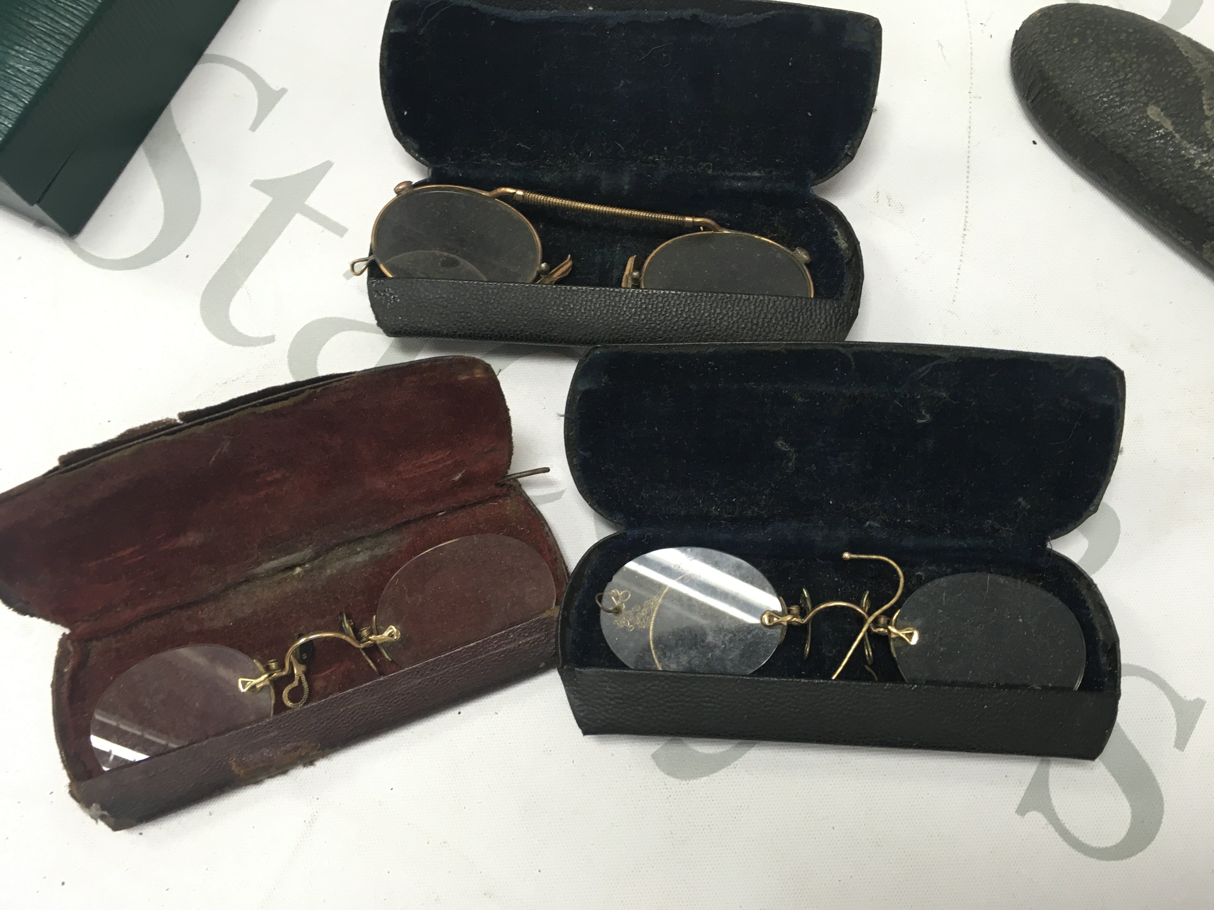 Four cased spectacles.