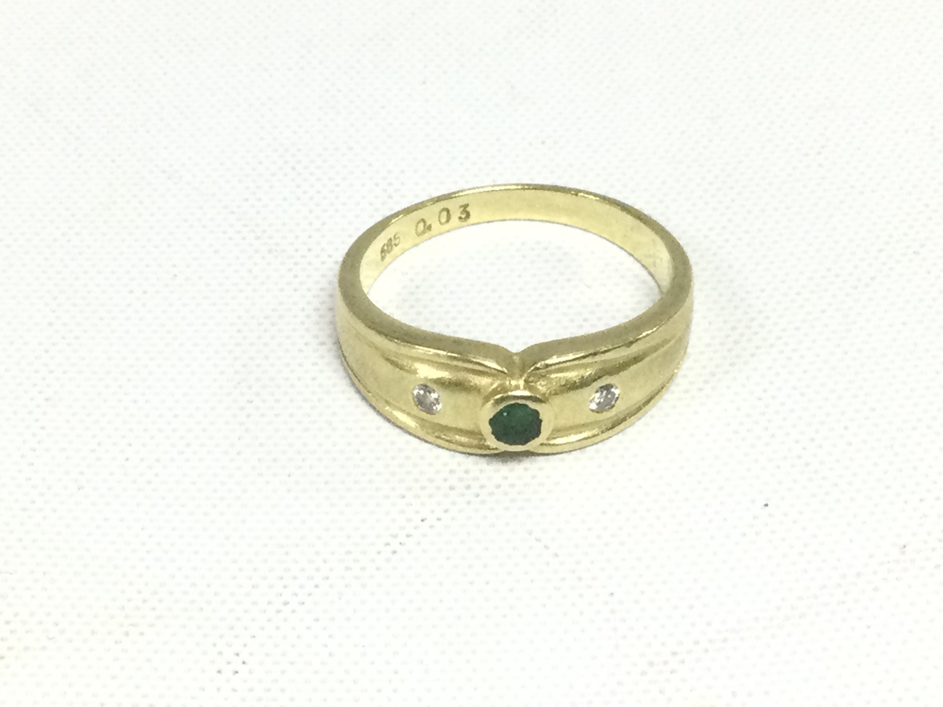A 14ct gold ring set with an emerald and two diamonds, approx 3.8g and approx size N. Shipping category A.