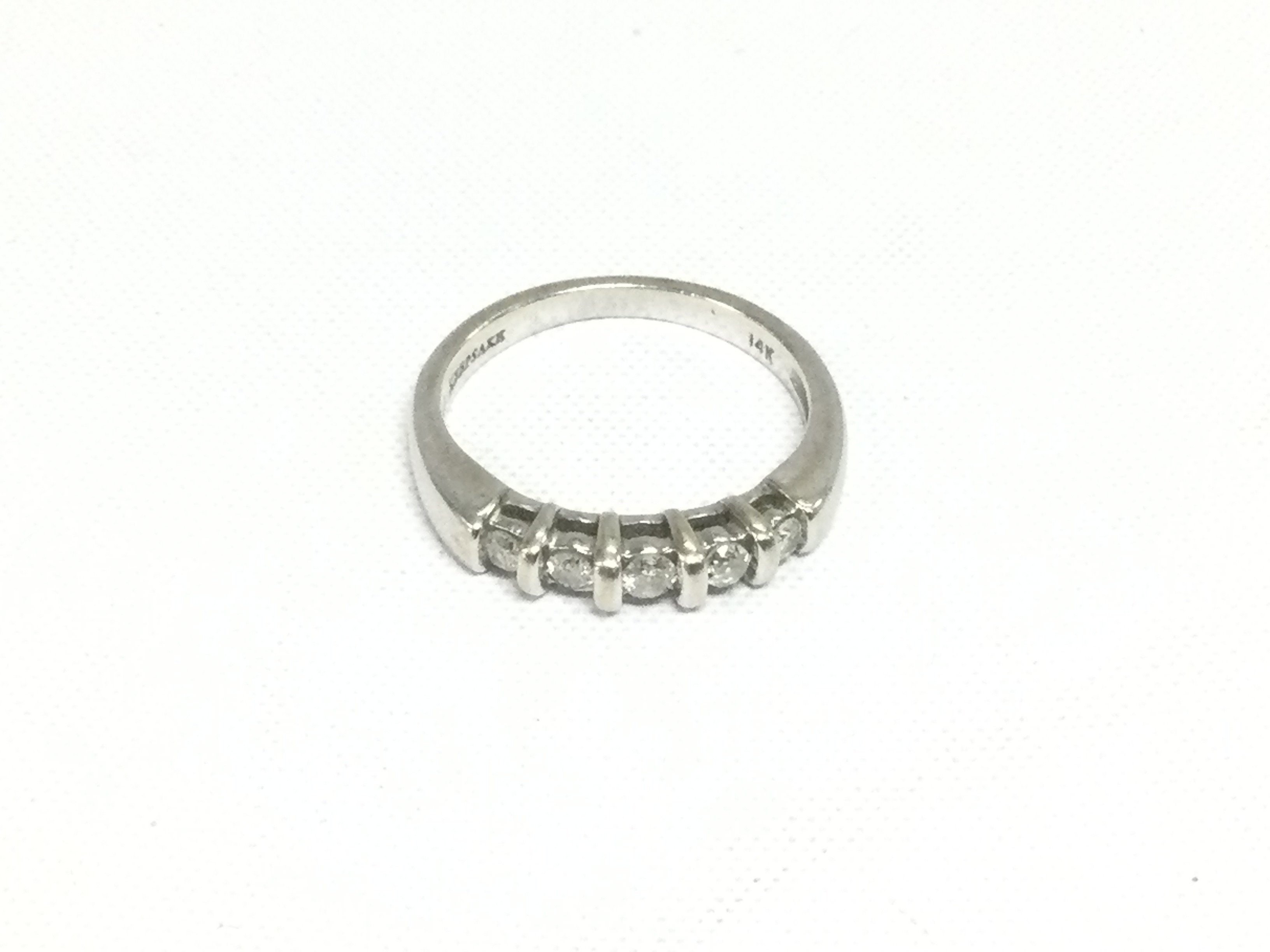 A 14ct white gold five stone diamond ring, approx 3.9g and approx size N. Shipping category A.