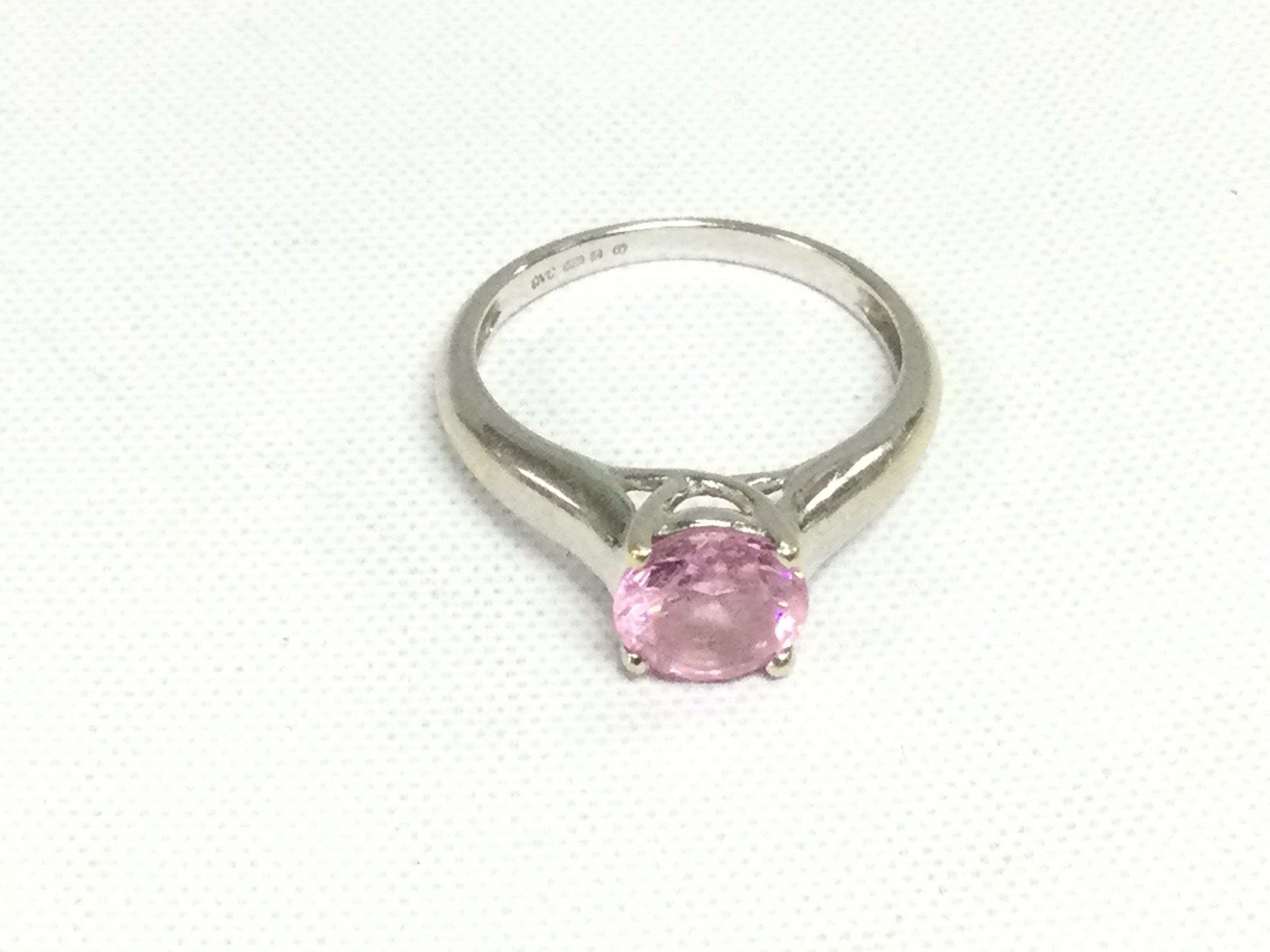 A 14k white gold solitaire ring set with a pink stone, possibly Morganite, approx 3g and approx size K-L. Shipping category A.