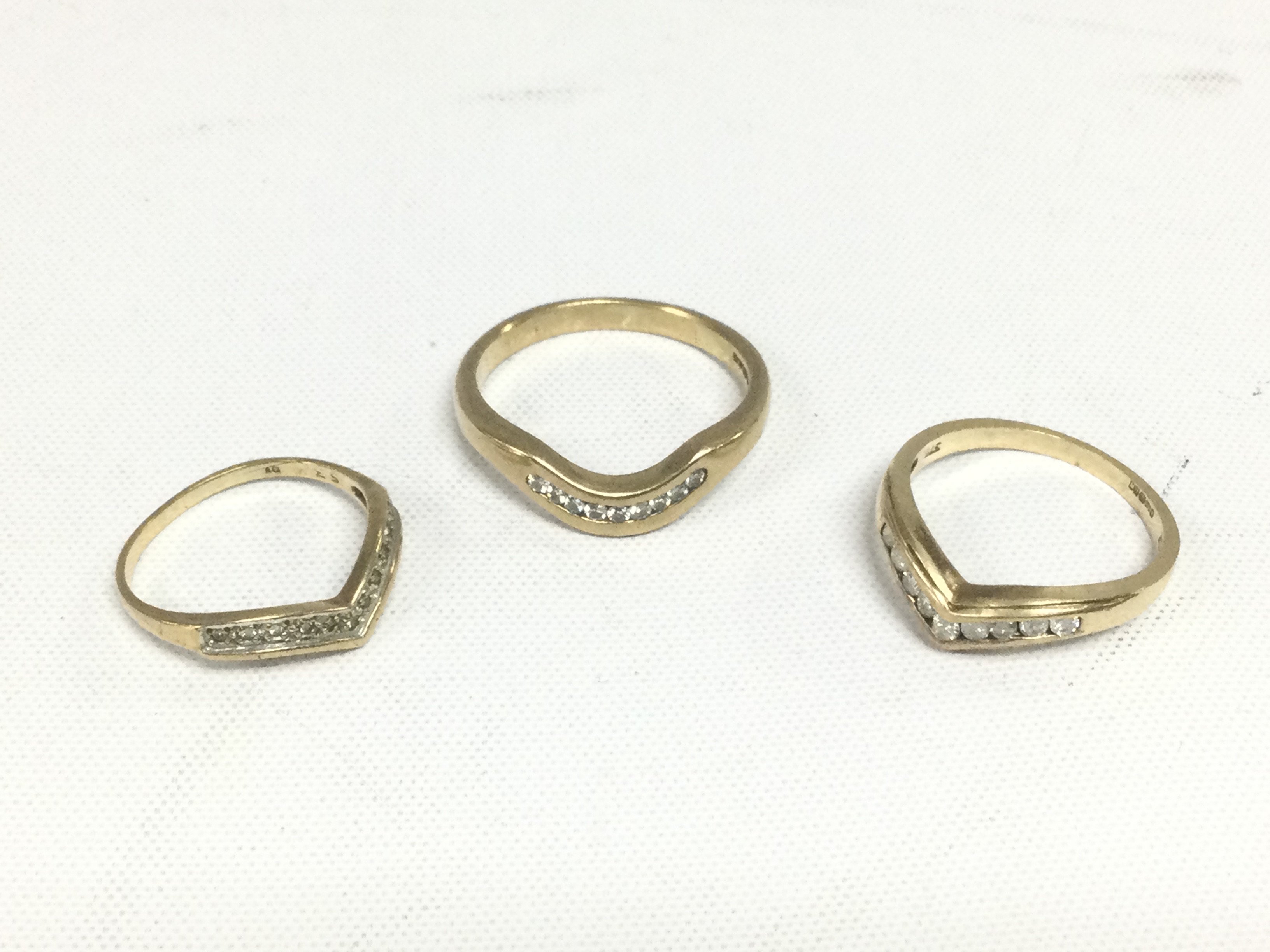 Three 9ct gold diamond wishbone rings, total approx 6.8g and approx sizes S, N and J. Shipping category A.
