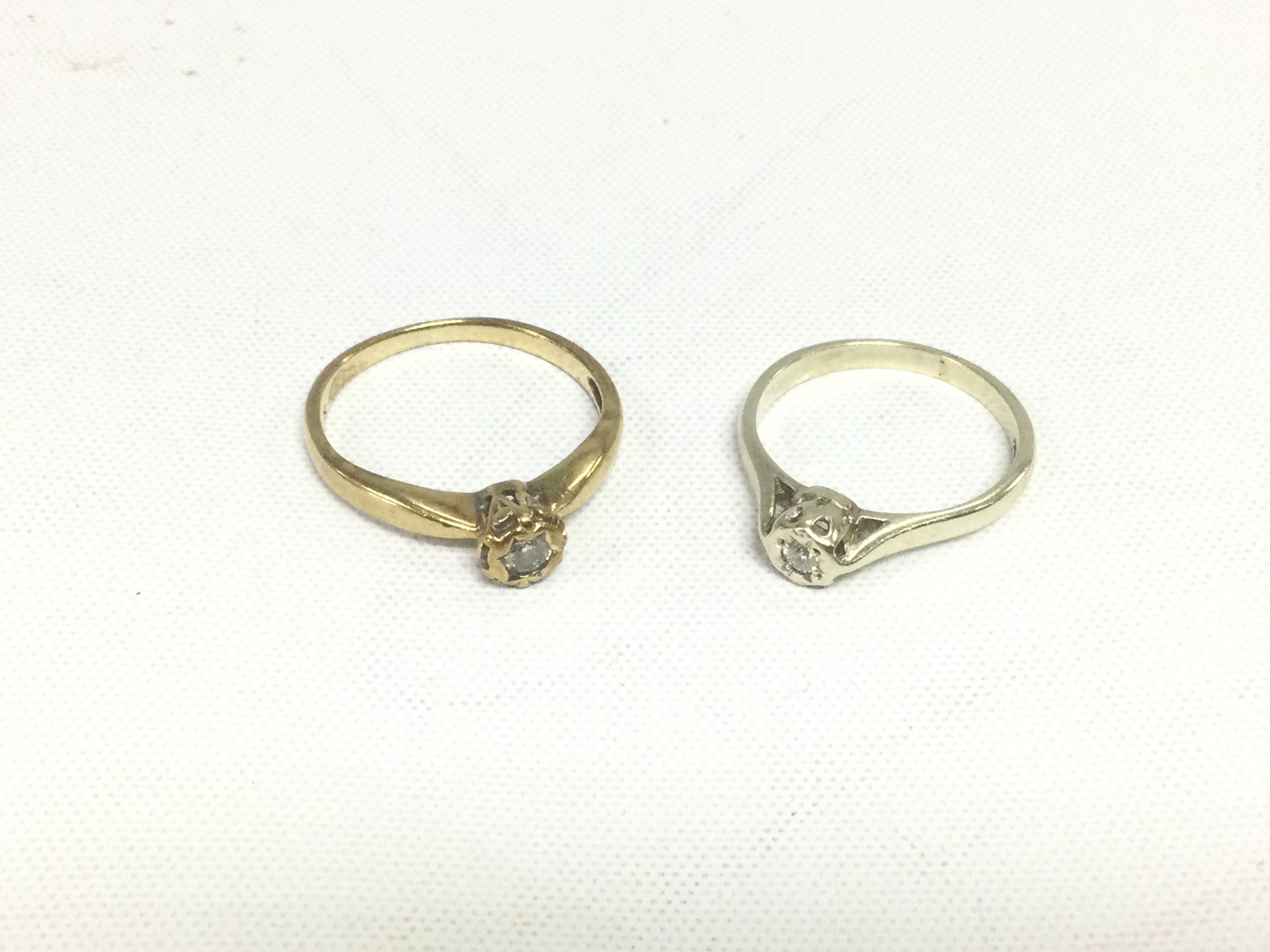 Two 9ct gold solitaire diamond rings, approx total weight 4g and approx sizes M and L. Shipping category A.