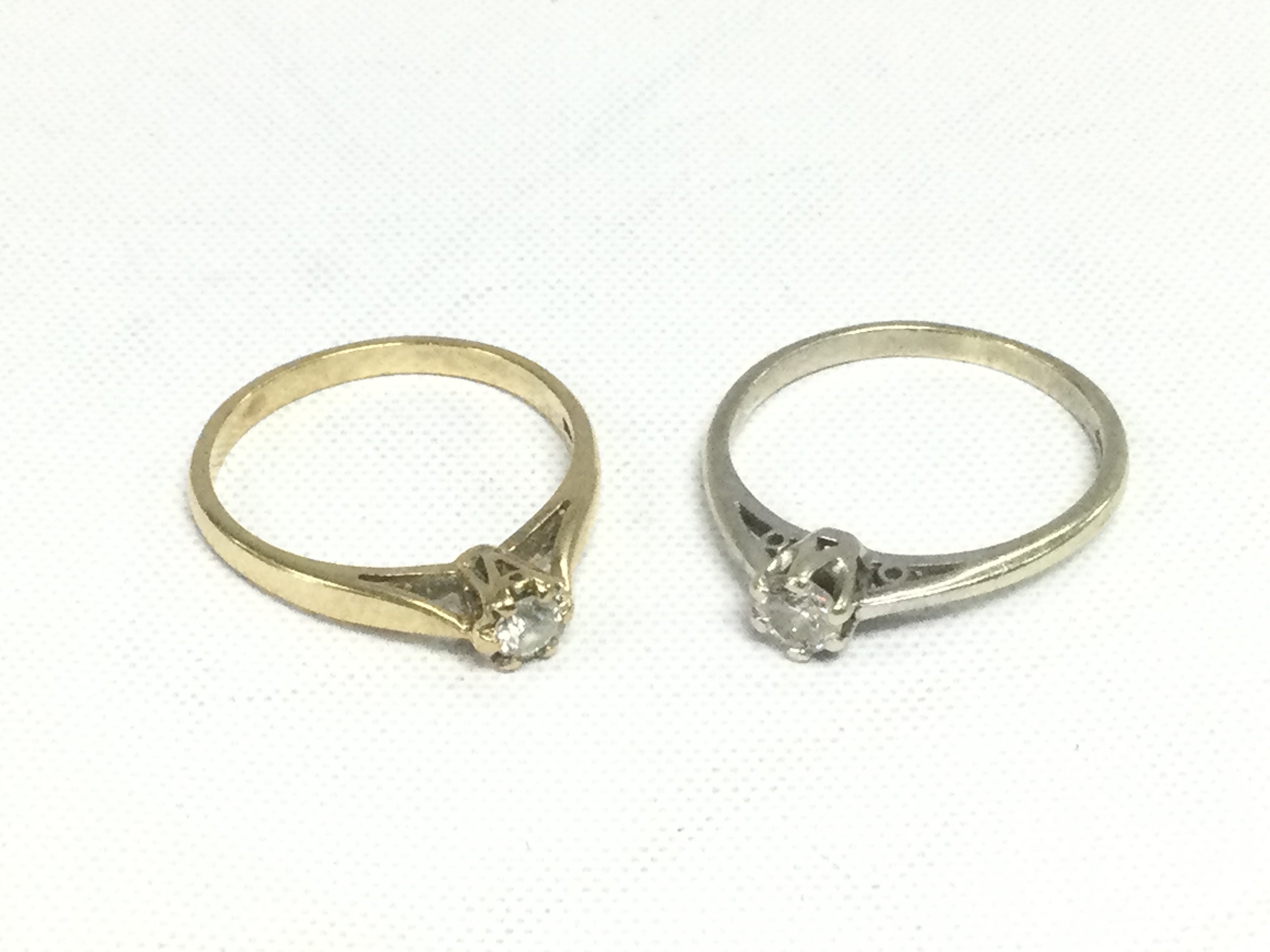 Two 9ct gold solitaire diamond rings, total approx weight 3.4g and approx sizes L and N. Shipping category A.