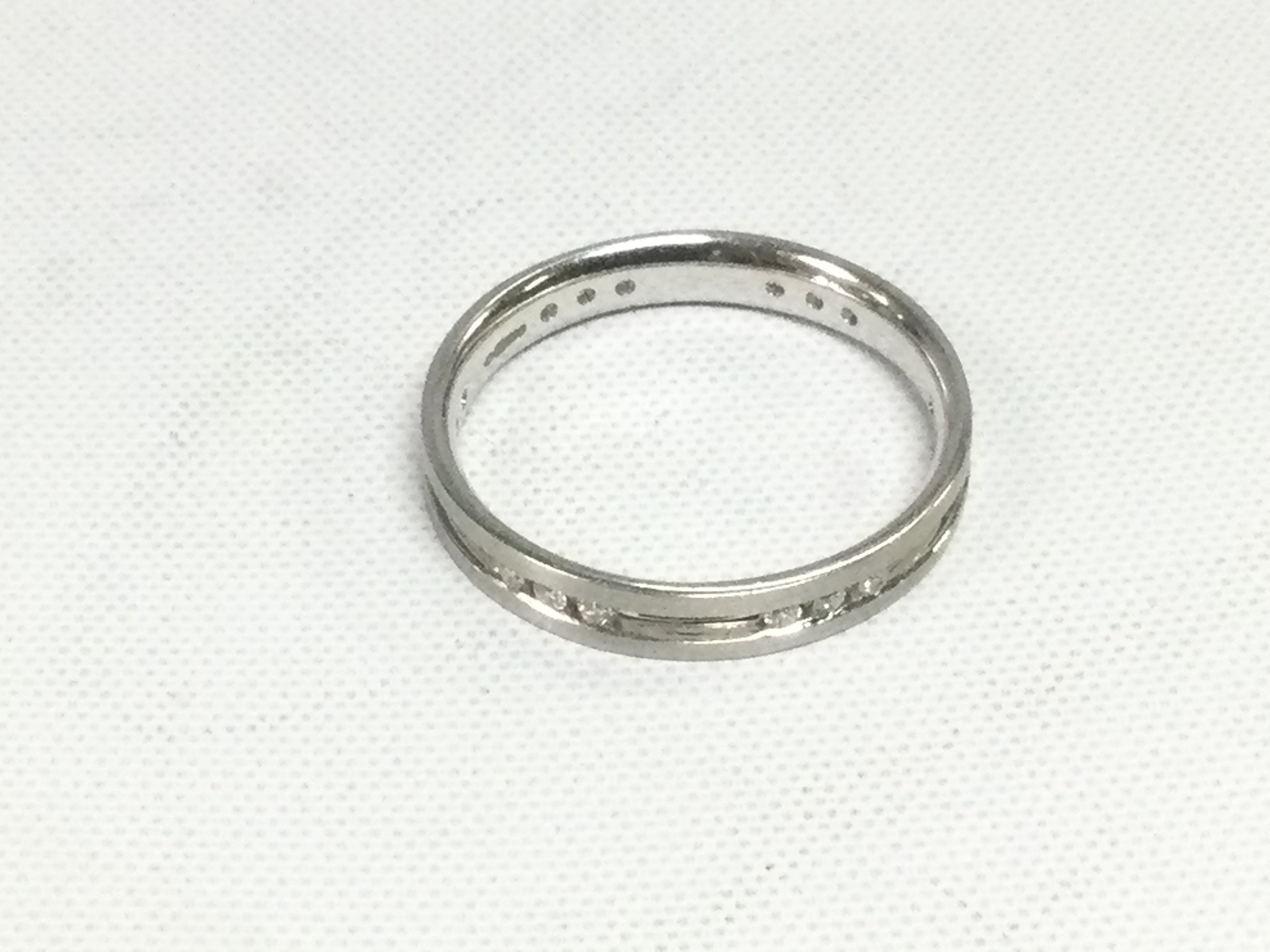 An 18ct white gold ring set with diamonds, approx 2.6g and approx size P. Shipping category A.