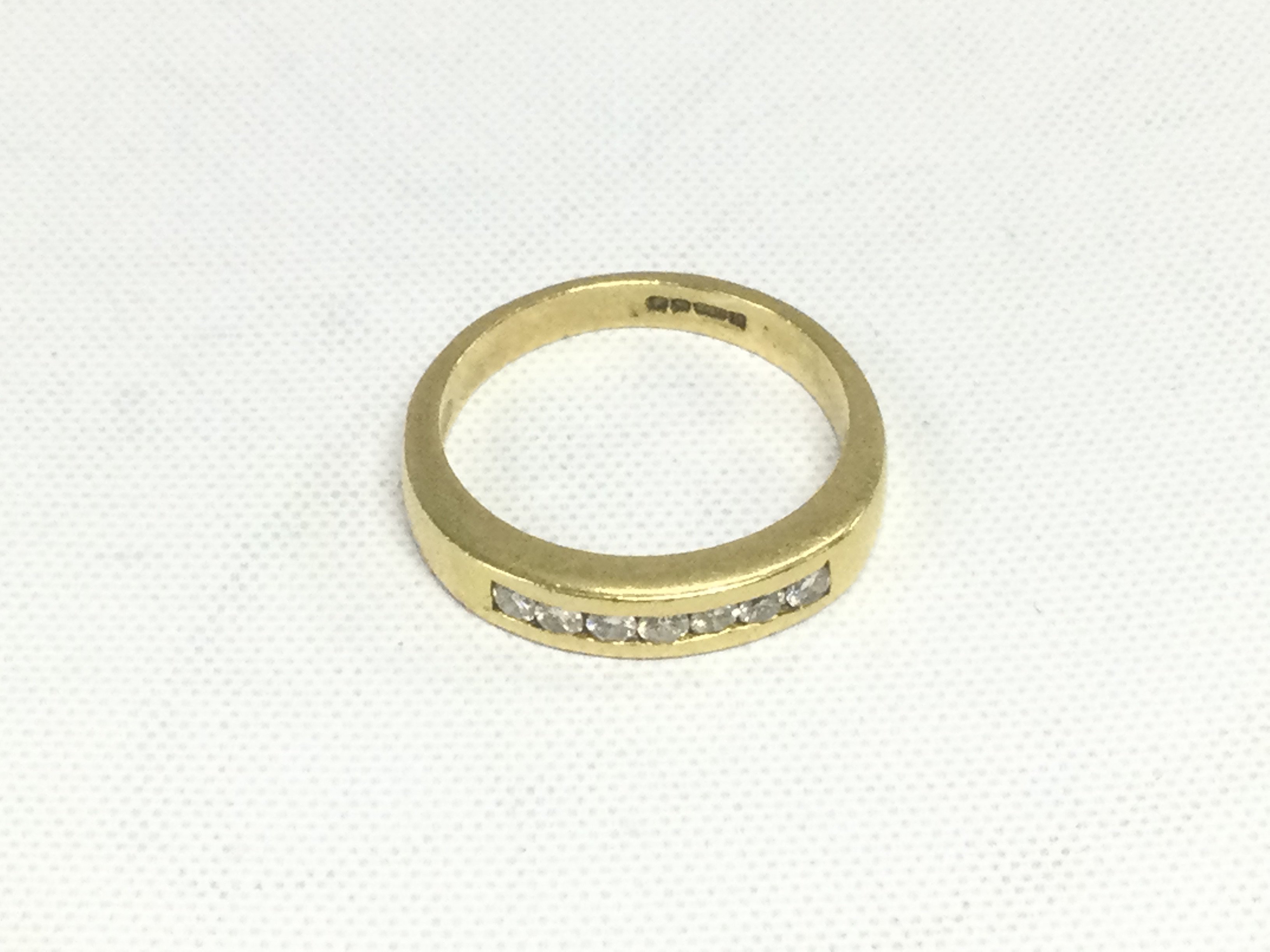 An 18ct gold diamond half hoop ring, approx 4.3g and approx size L. Shipping category A.