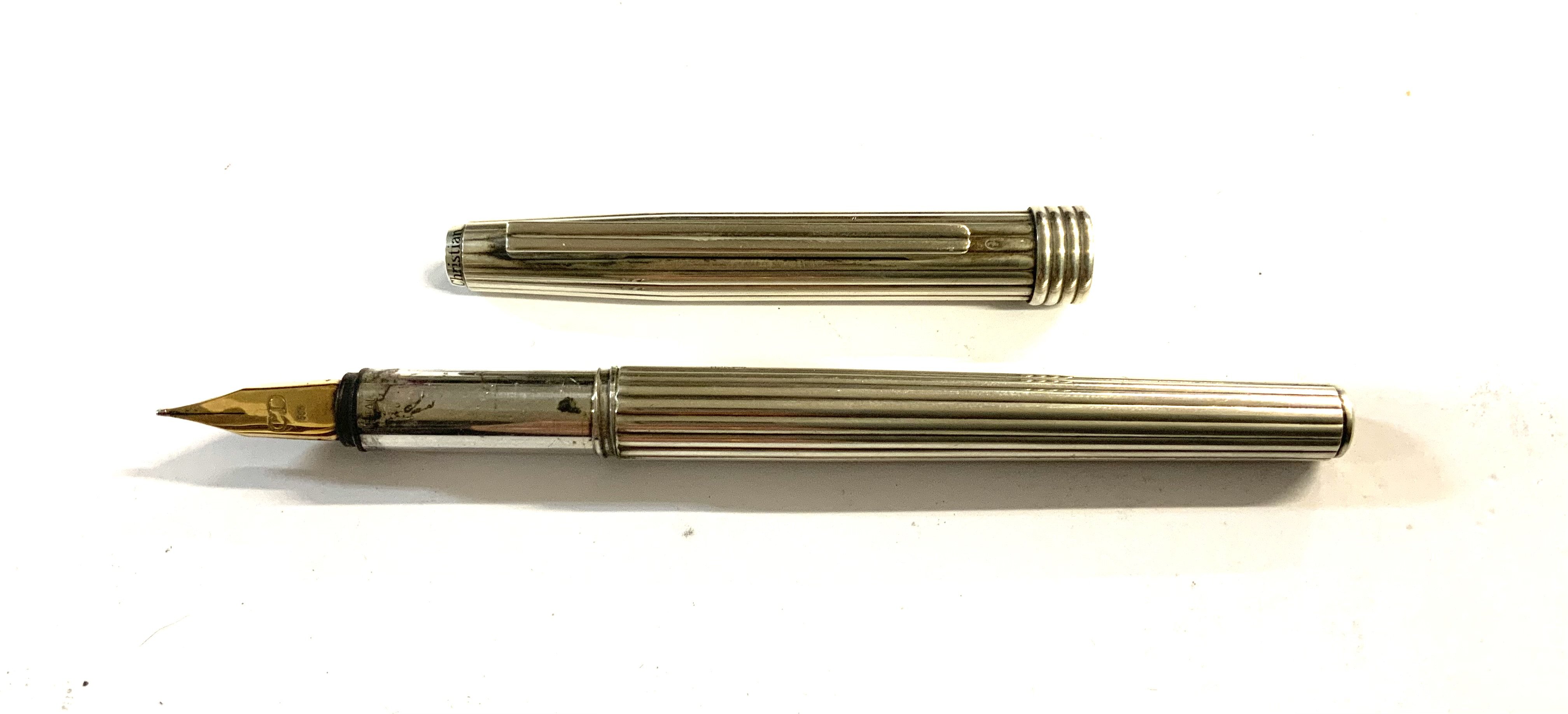 A Sterling silver Christian Dior fountain pen with a 14K gold nib. (A)