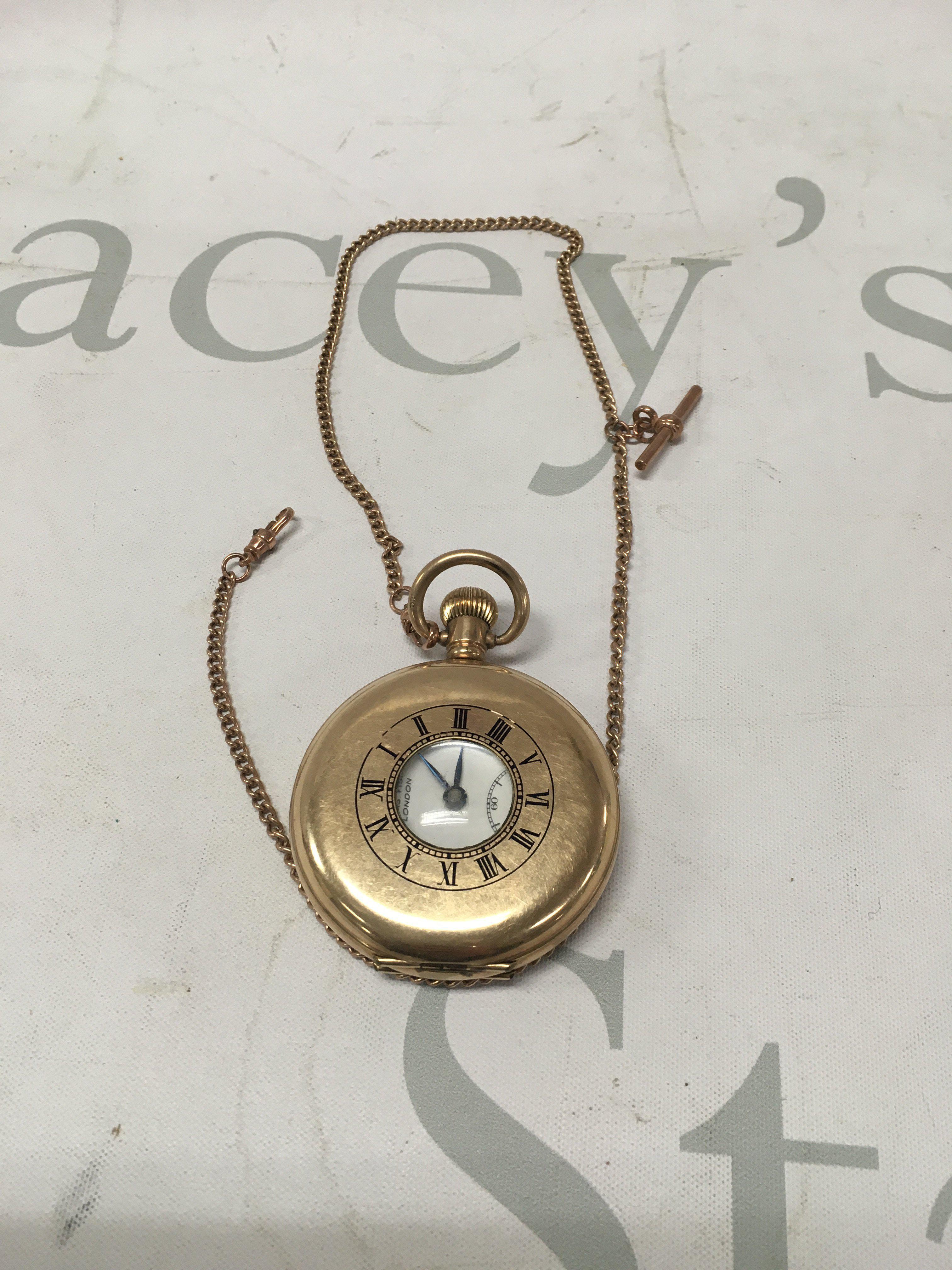 A gold plated hunter pocket watch with a 9 ct gold chain 5 grams.