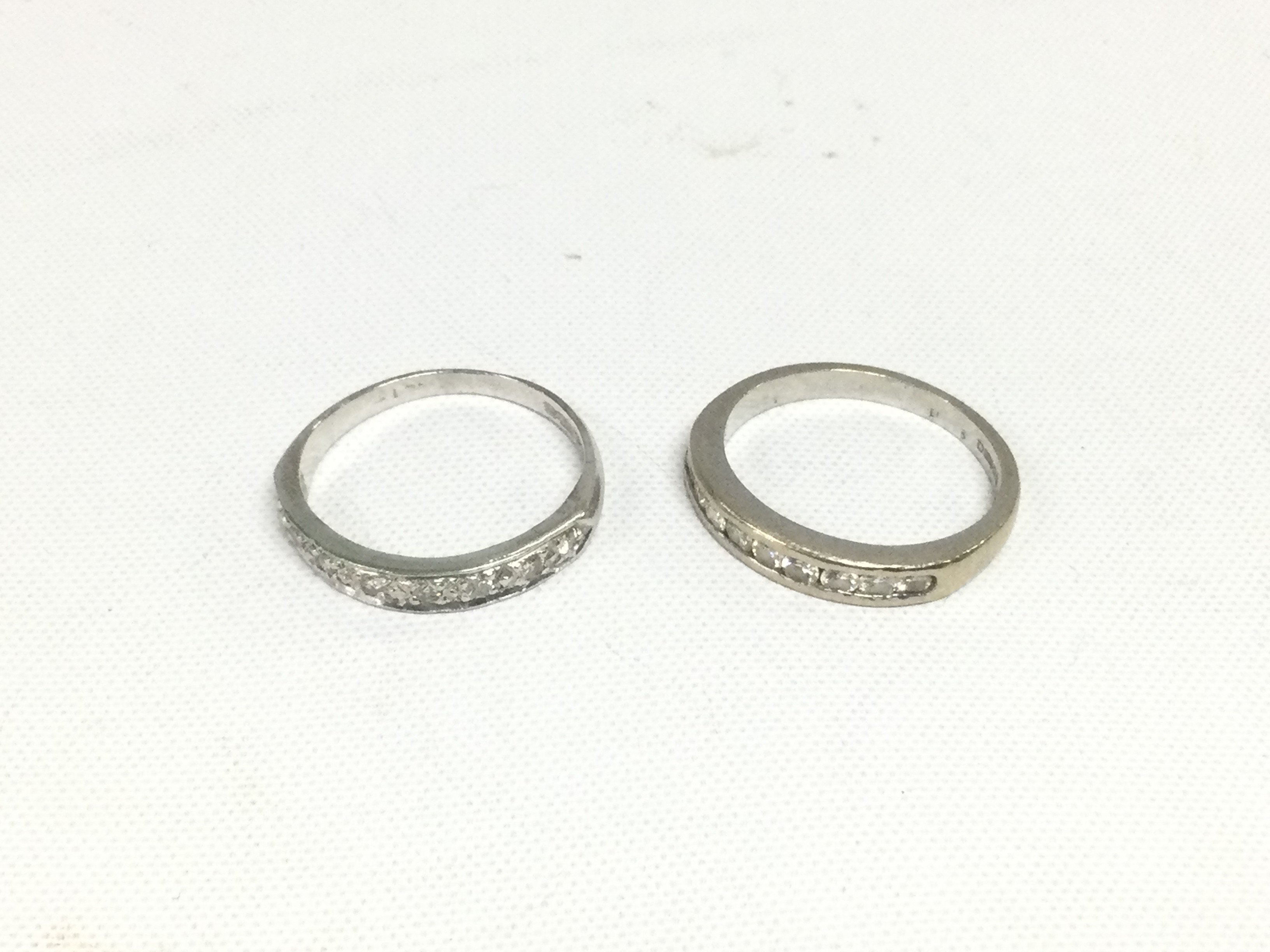 Two 18ct white gold half hoop diamond rings, approx total weight 5.6g and approx size M. Shipping category A.