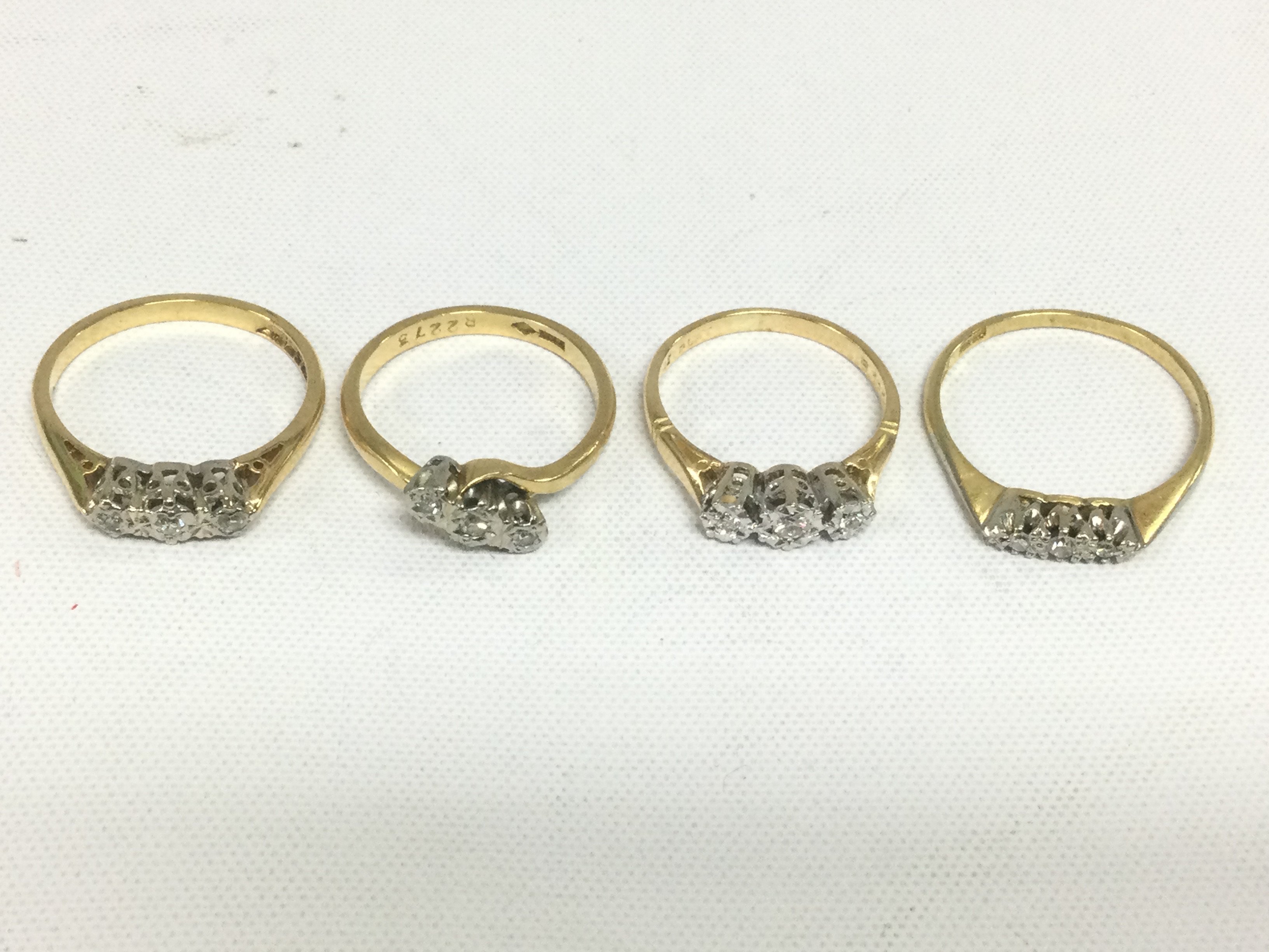 Four 18ct gold three stone diamond rings, approx total weight 10.4g and approx sizes K,L,N and P. Shipping category A.