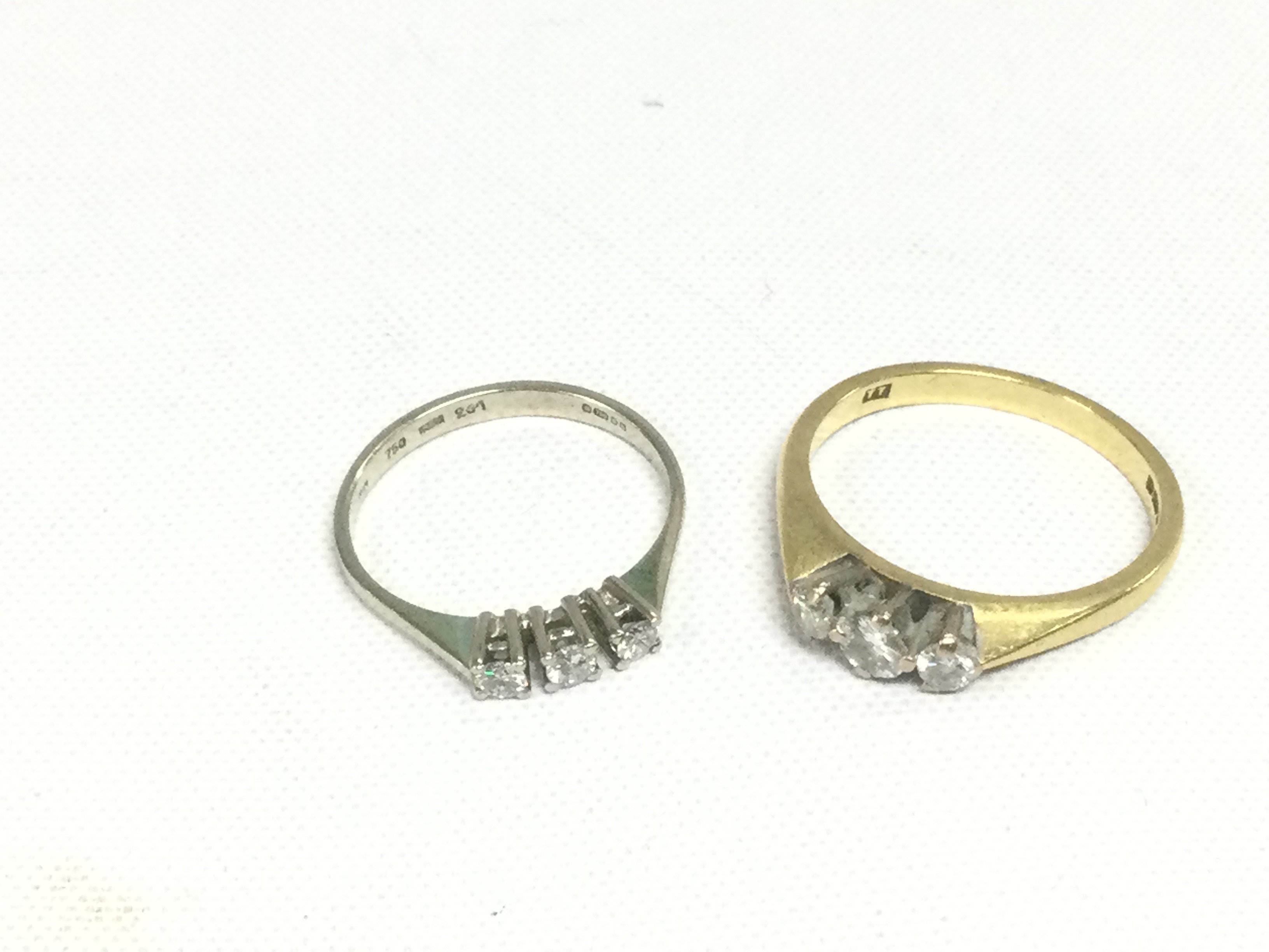 Two 18ct gold three stone diamond rings, approx 4.2g and approx sizes G-H and L. Shipping category A.