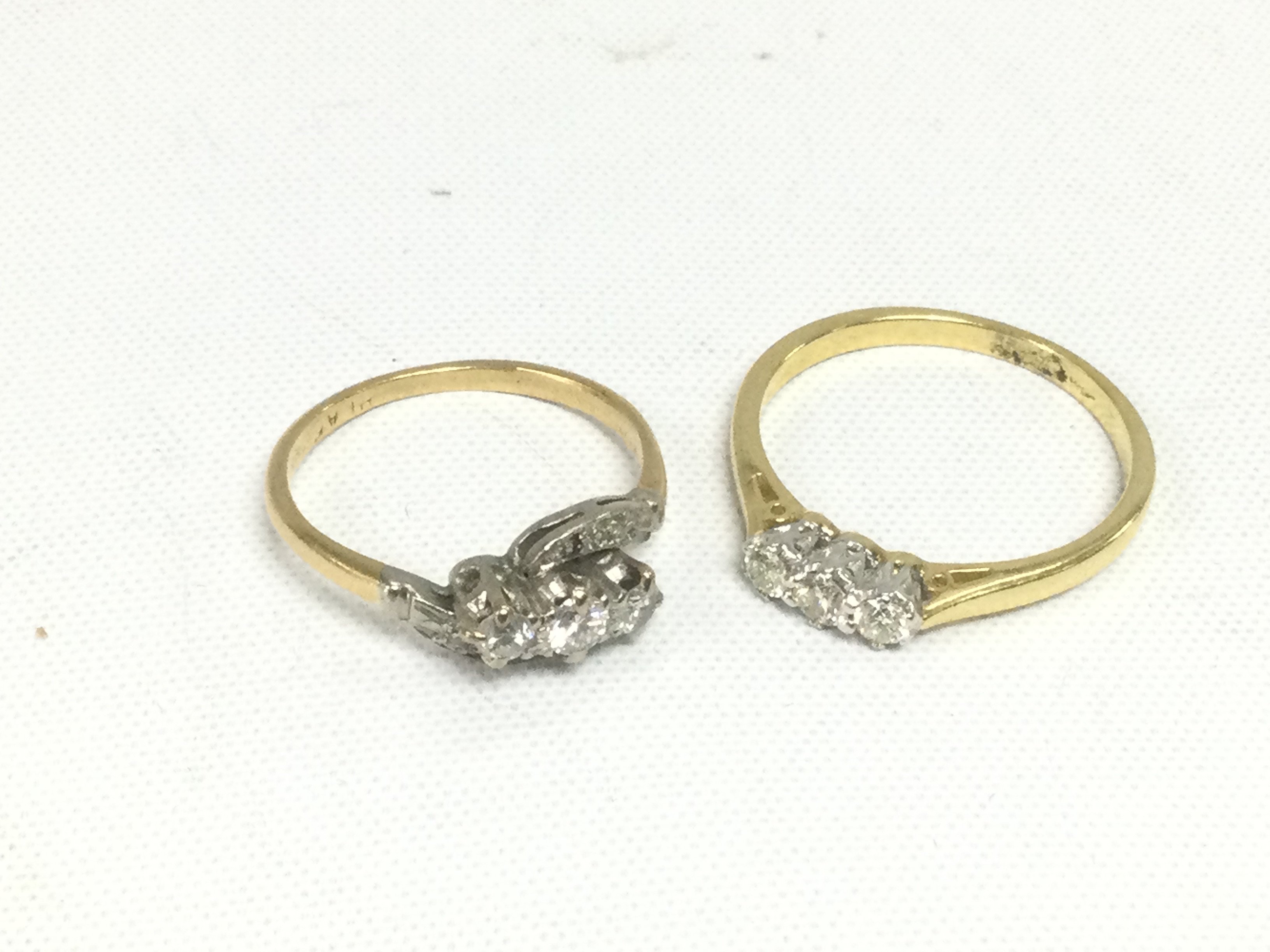Two 18ct gold three stone diamond rings, total approx weight 5.3g and approx sizes L and Q. Shipping category A.