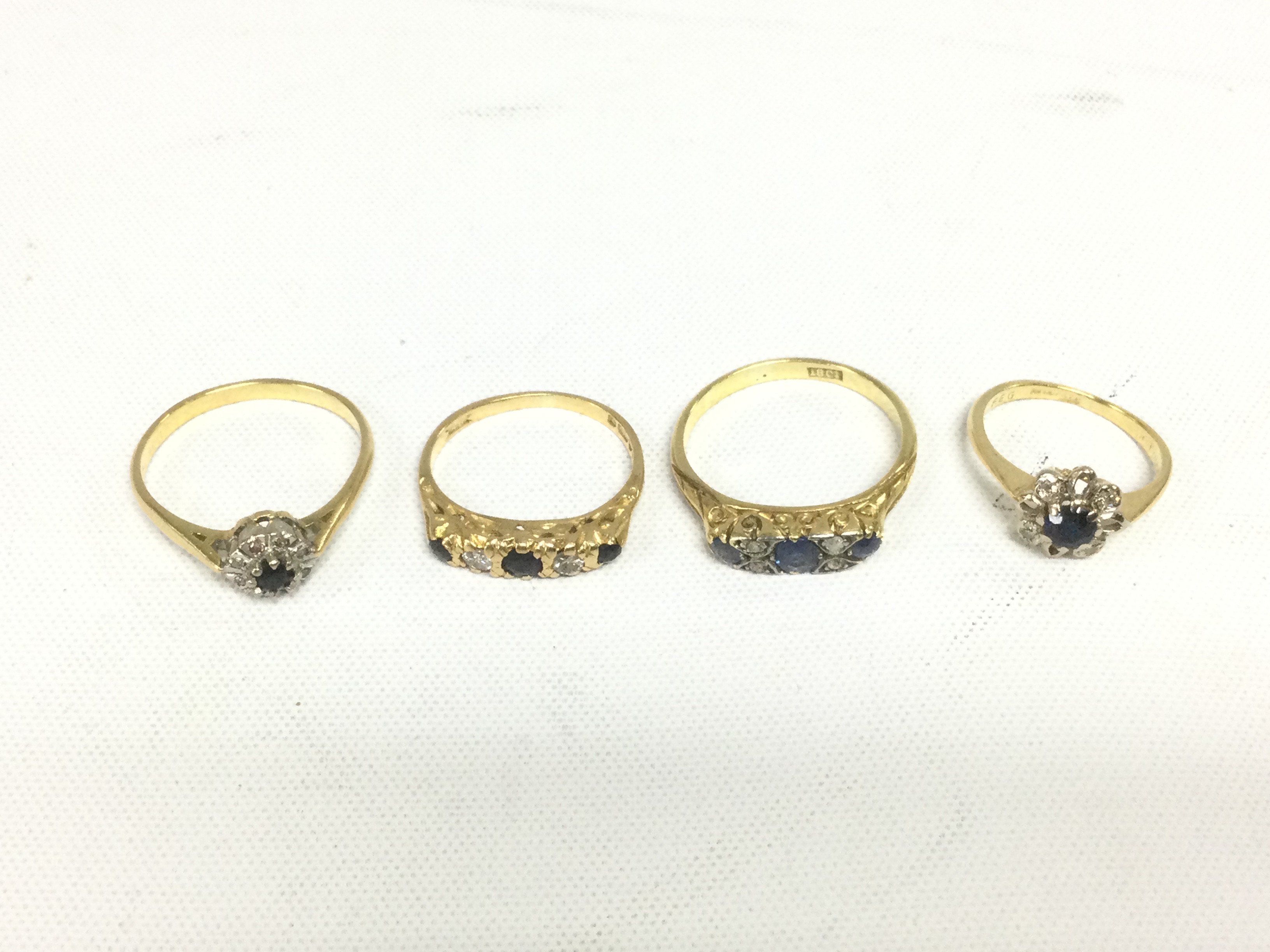 Four 18ct gold rings se with diamonds and sapphires, approx total weight 9.6g. Shipping category A.