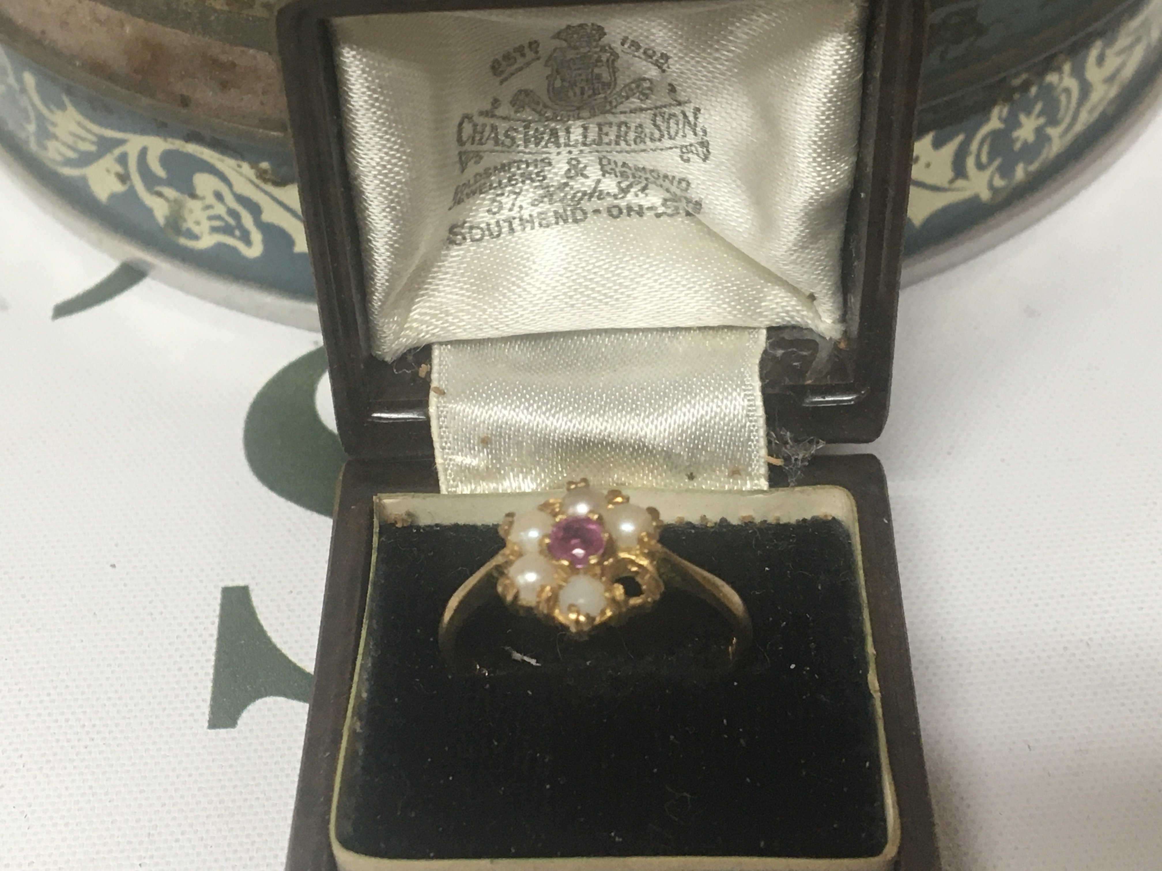 A 9carat gold ring set with ruby and small pearls stone missing weight 1.5g