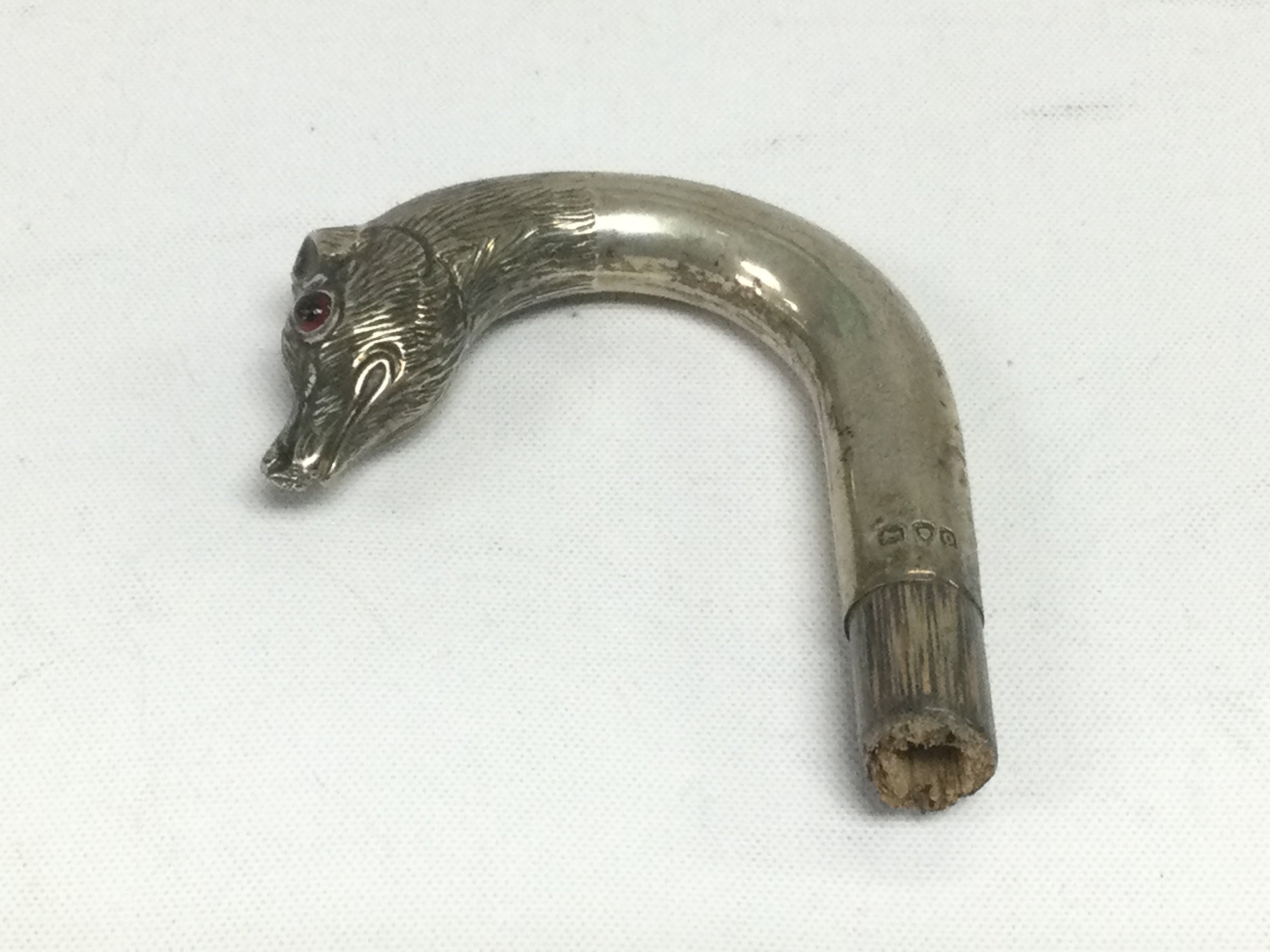 A silver topped cane handle. Shipping category A.
