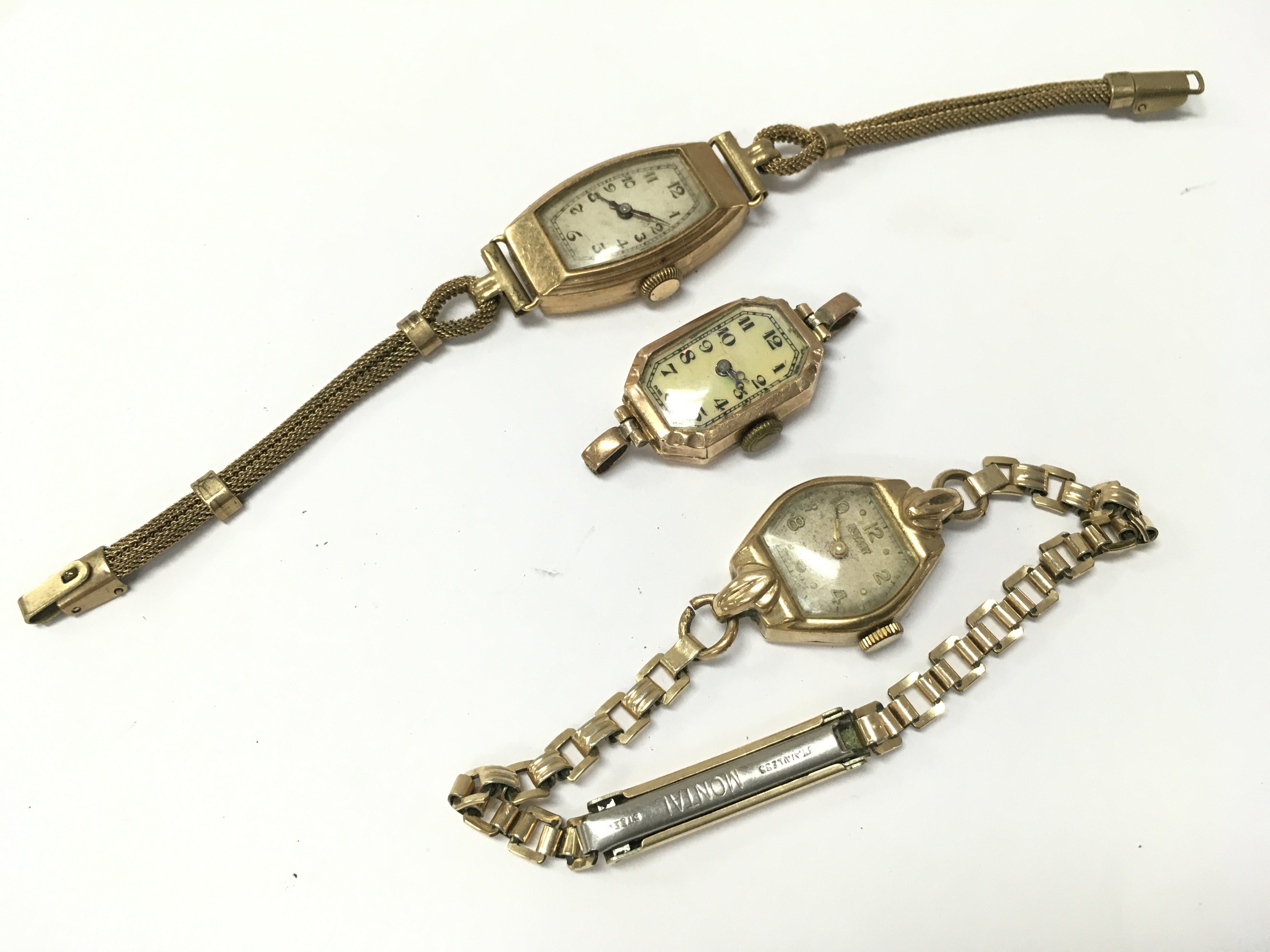 Three 9ct gold cased ladies watches with stainless steel and rolled gold straps . 29.8g total weight. Postage category A