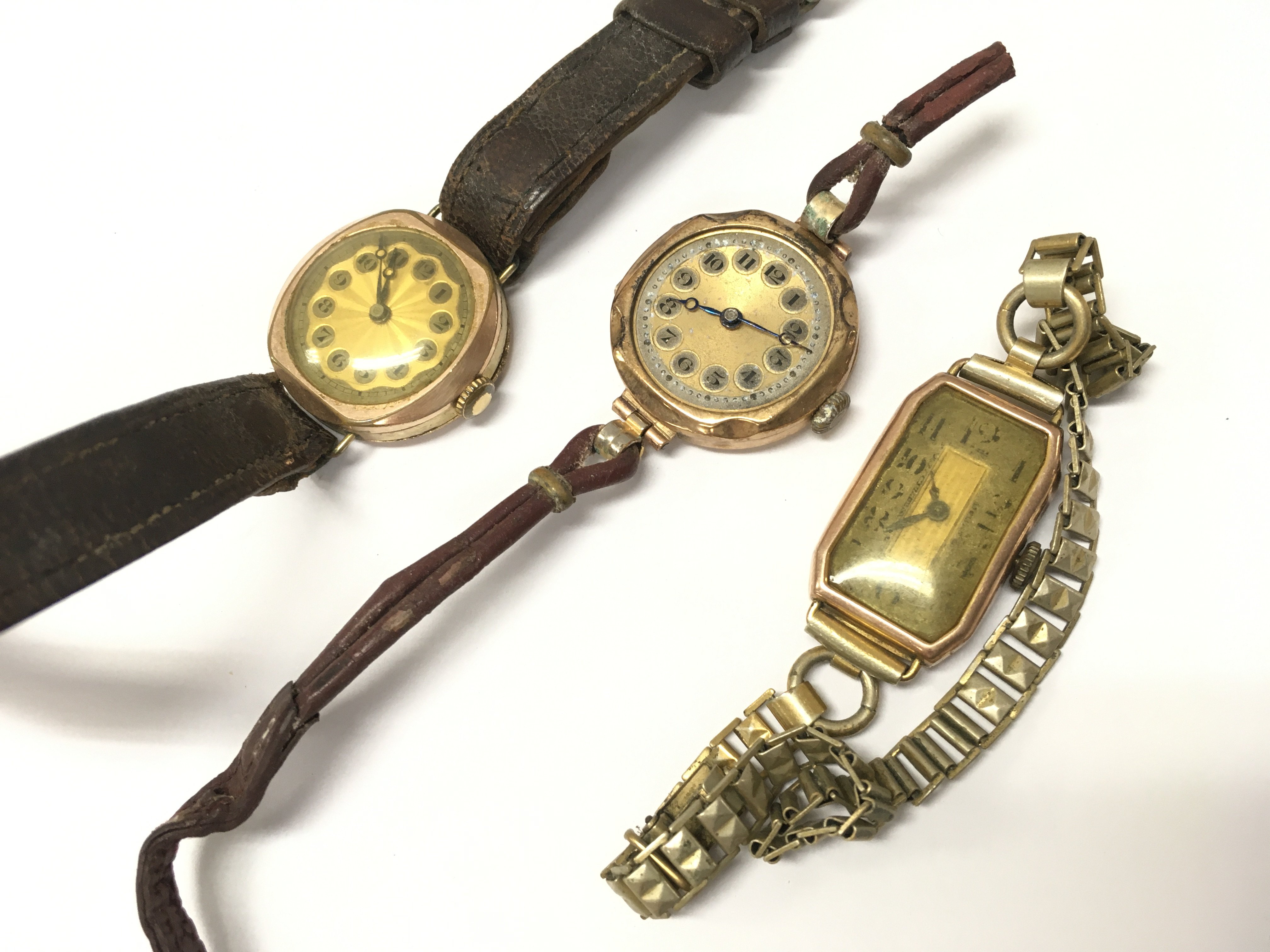 Two 9ct gold cased watches and a gold plated watch . Postage category A