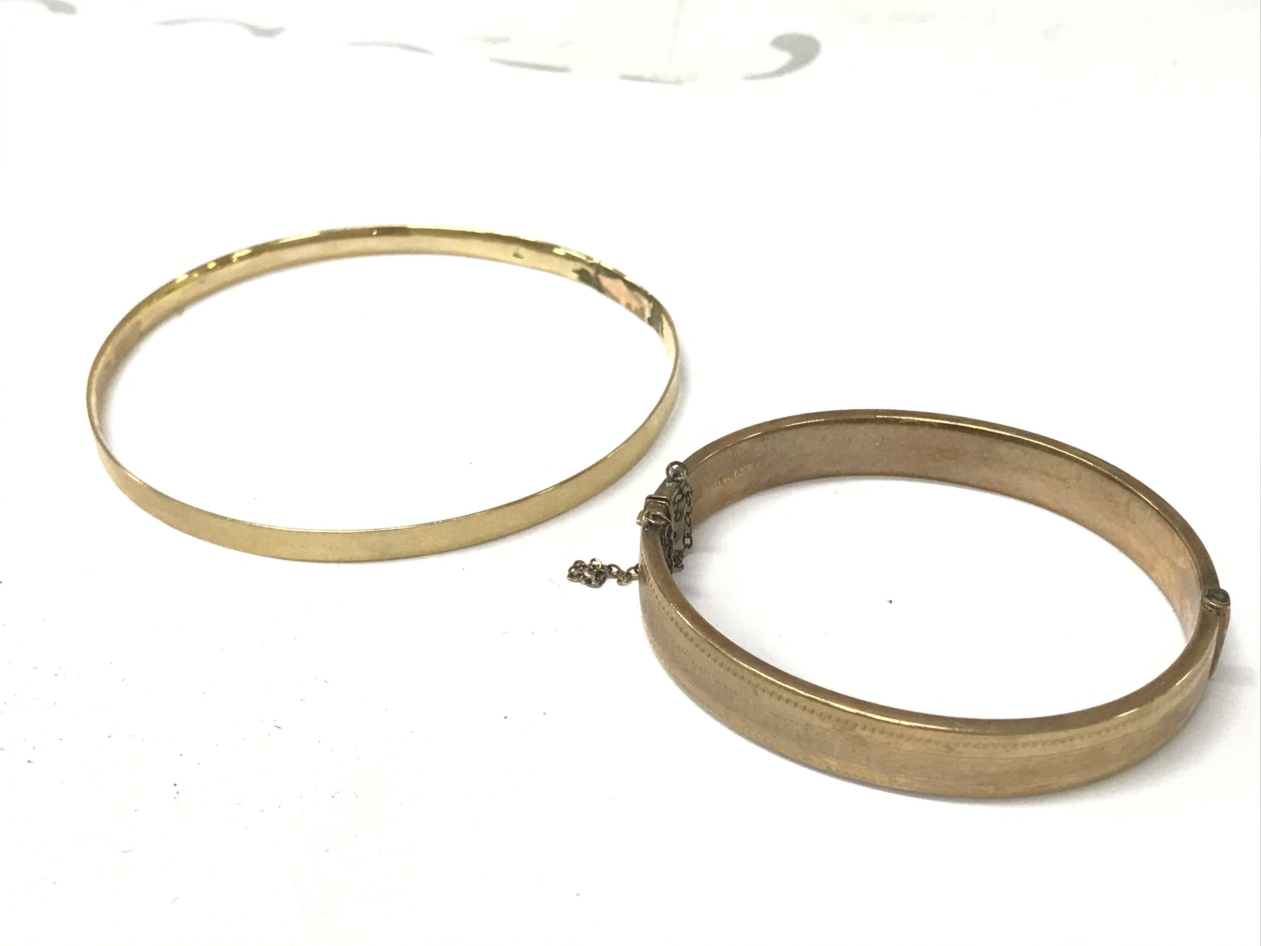 Two gold tone bangles . Postage category A