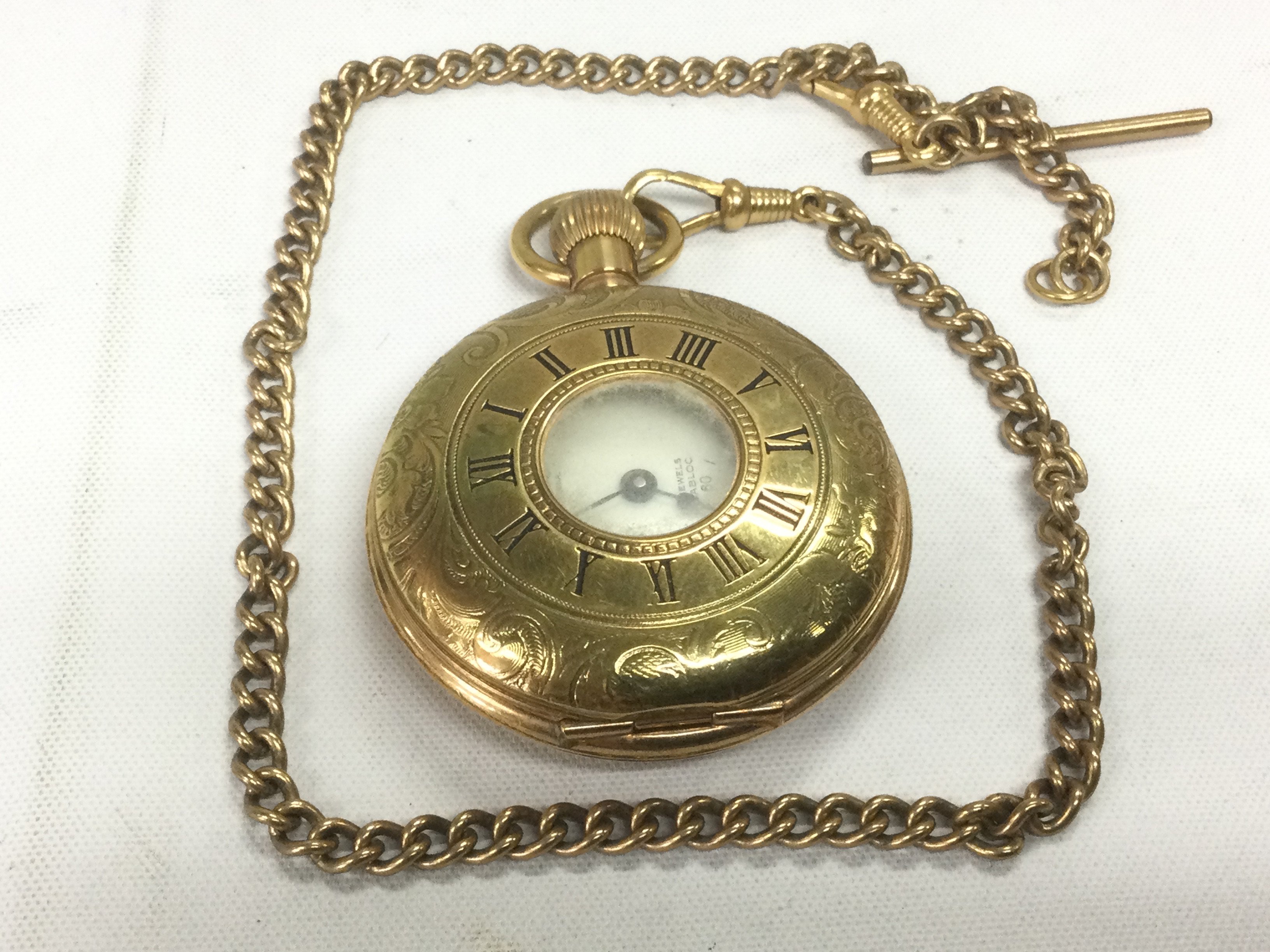 A yellow metal half hunter fob watch and chain. Shipping category A.