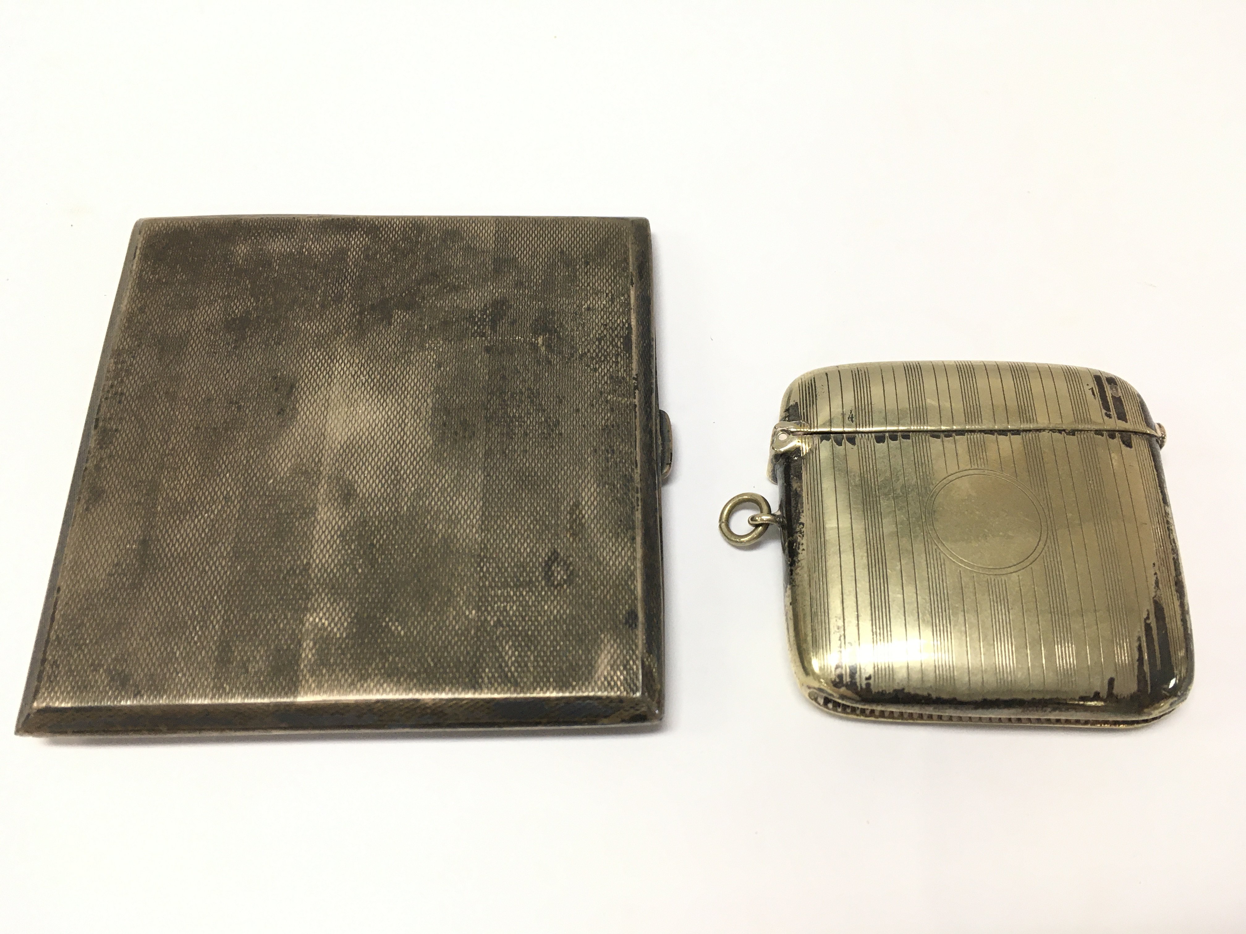 A silver plated vesta case and a silver hallmarked cigarette box . Postage category A