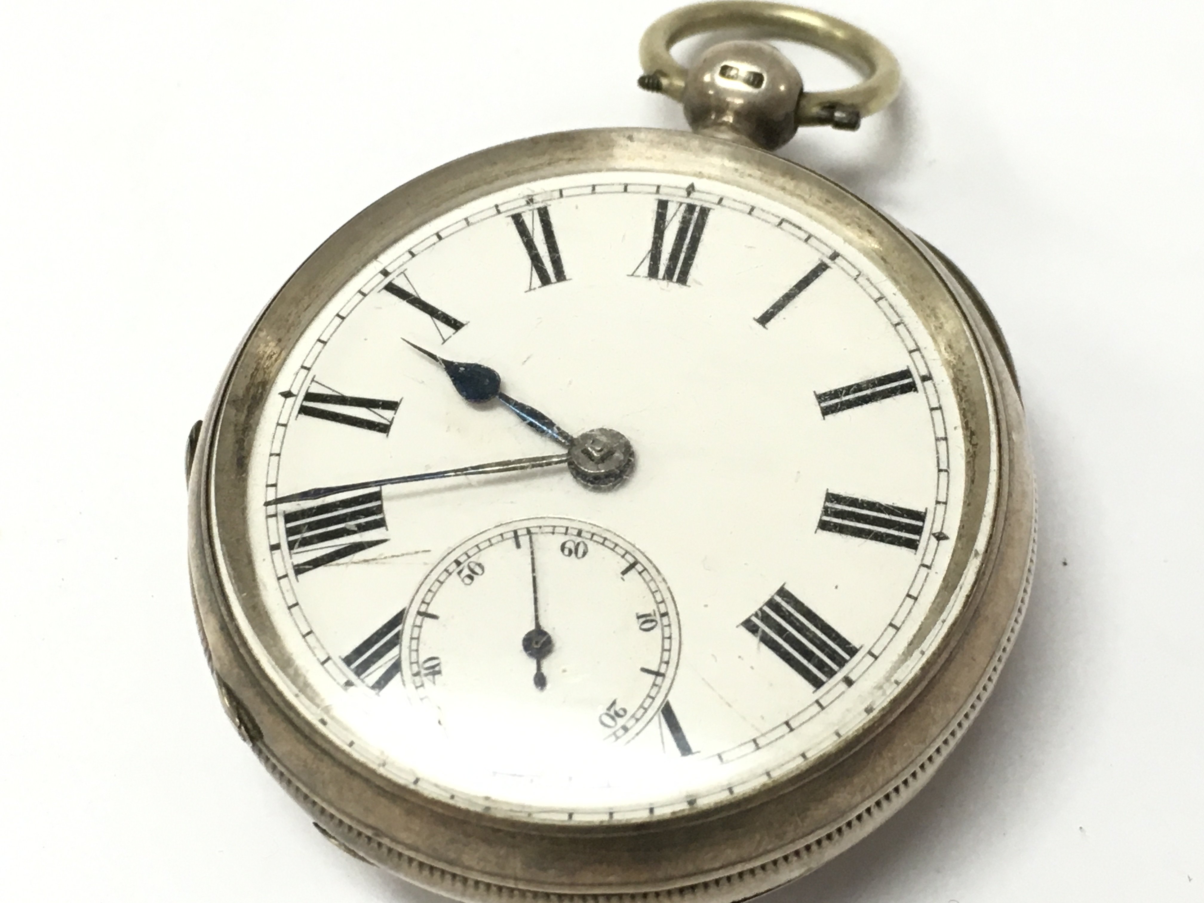 A hallmarked silver pocket watch, seen working. Postage category A
