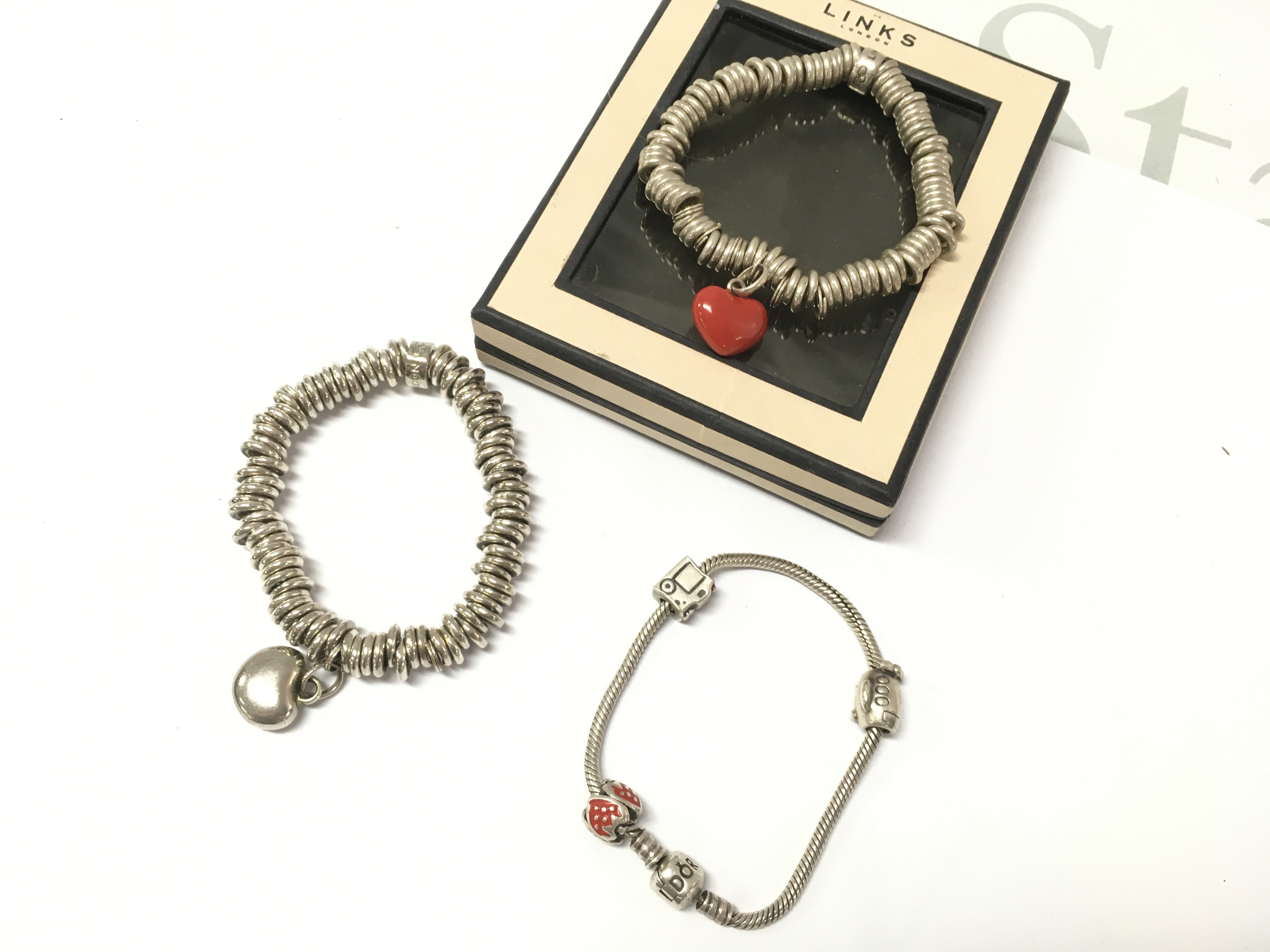 Two Links of London bracelets and a Pandora style charm bracelet . Postage category A