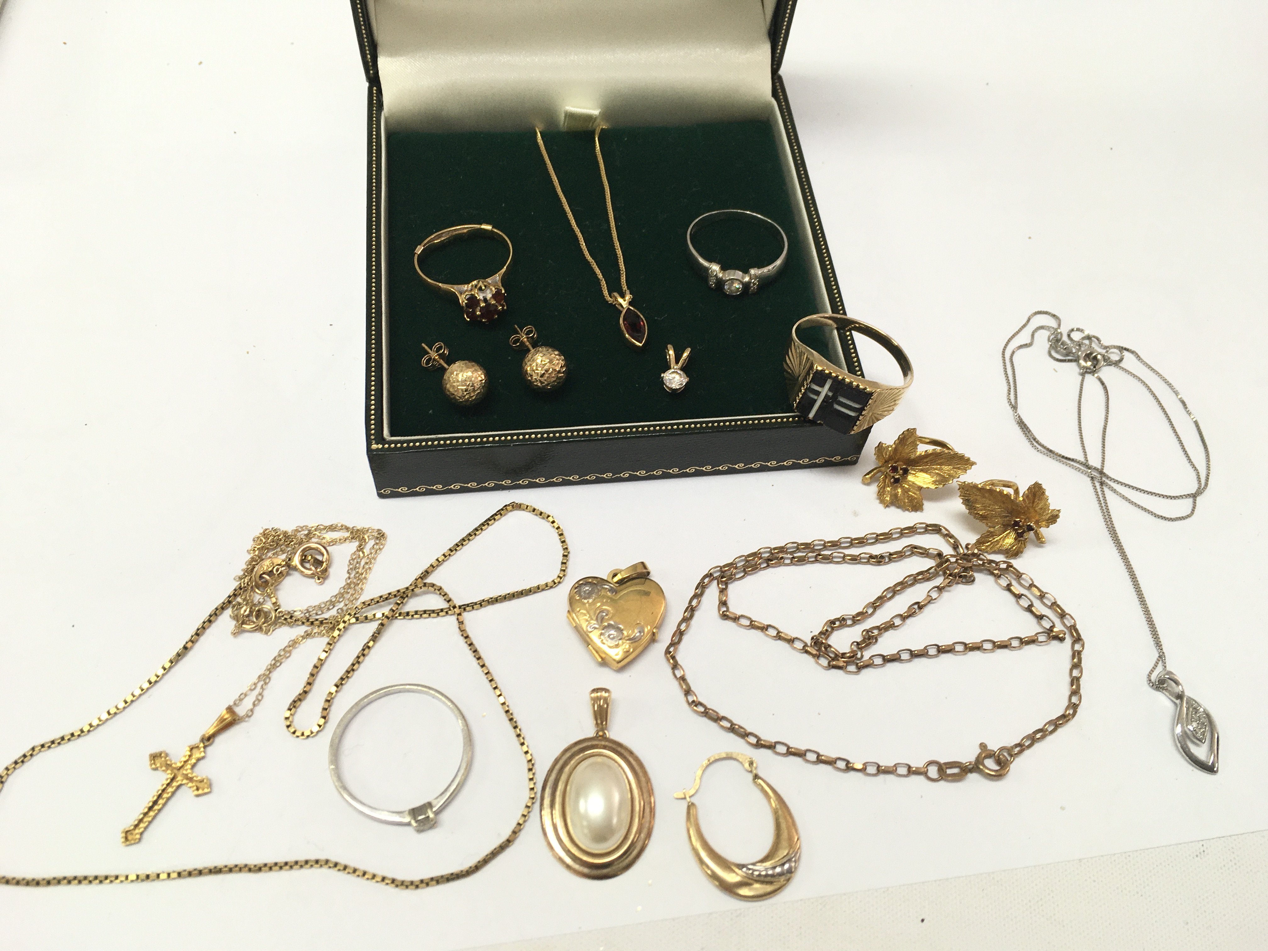 A collection of 9ct gold including rings, pendants, necklaces one set with a ruby pendant etc. total approximately 28g. postage category A