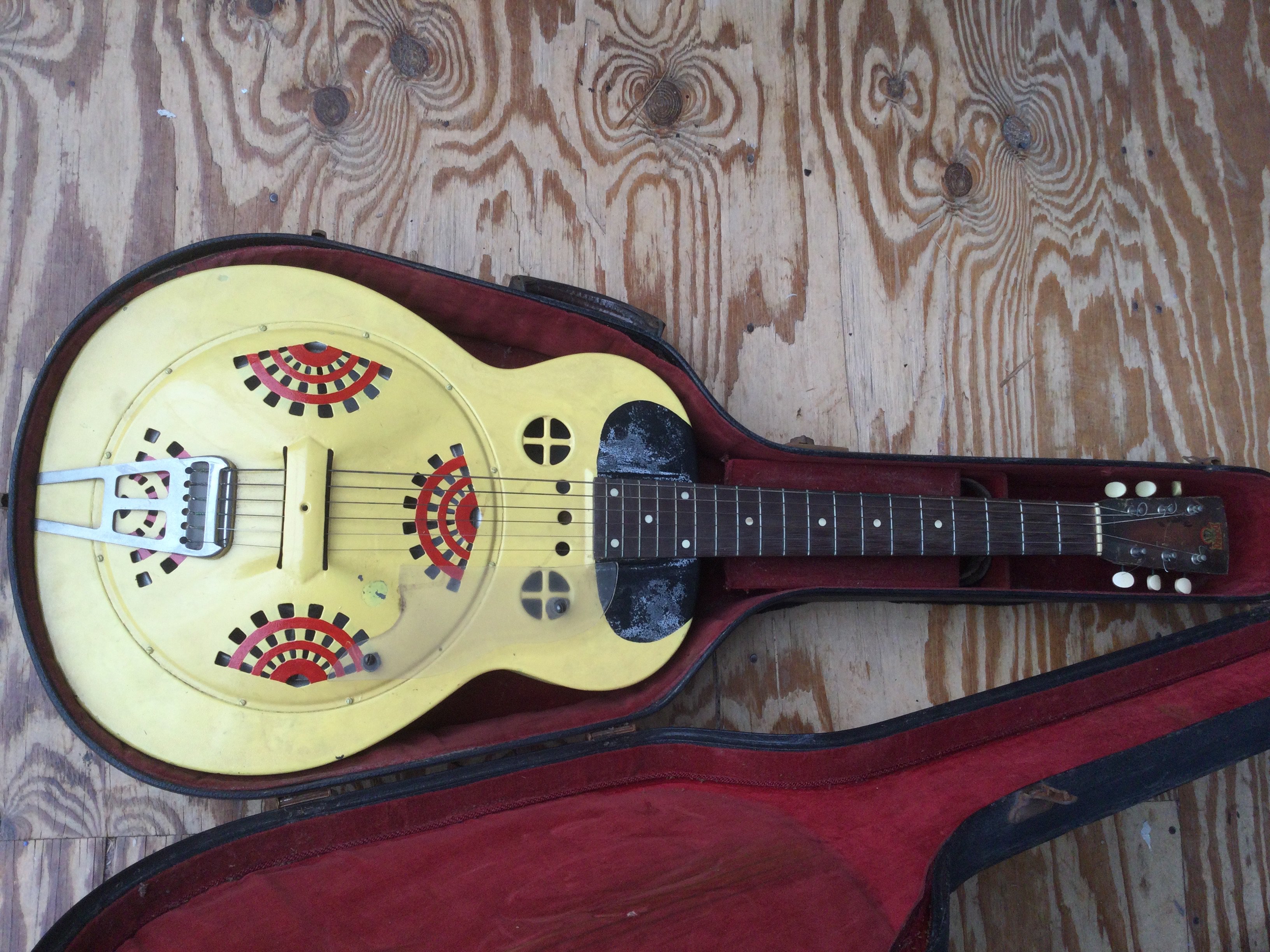 A 1936 Dobro M32 resonator guitar with gold frosted duco finish, later over painting to front of body. Comes with a hard carry case.