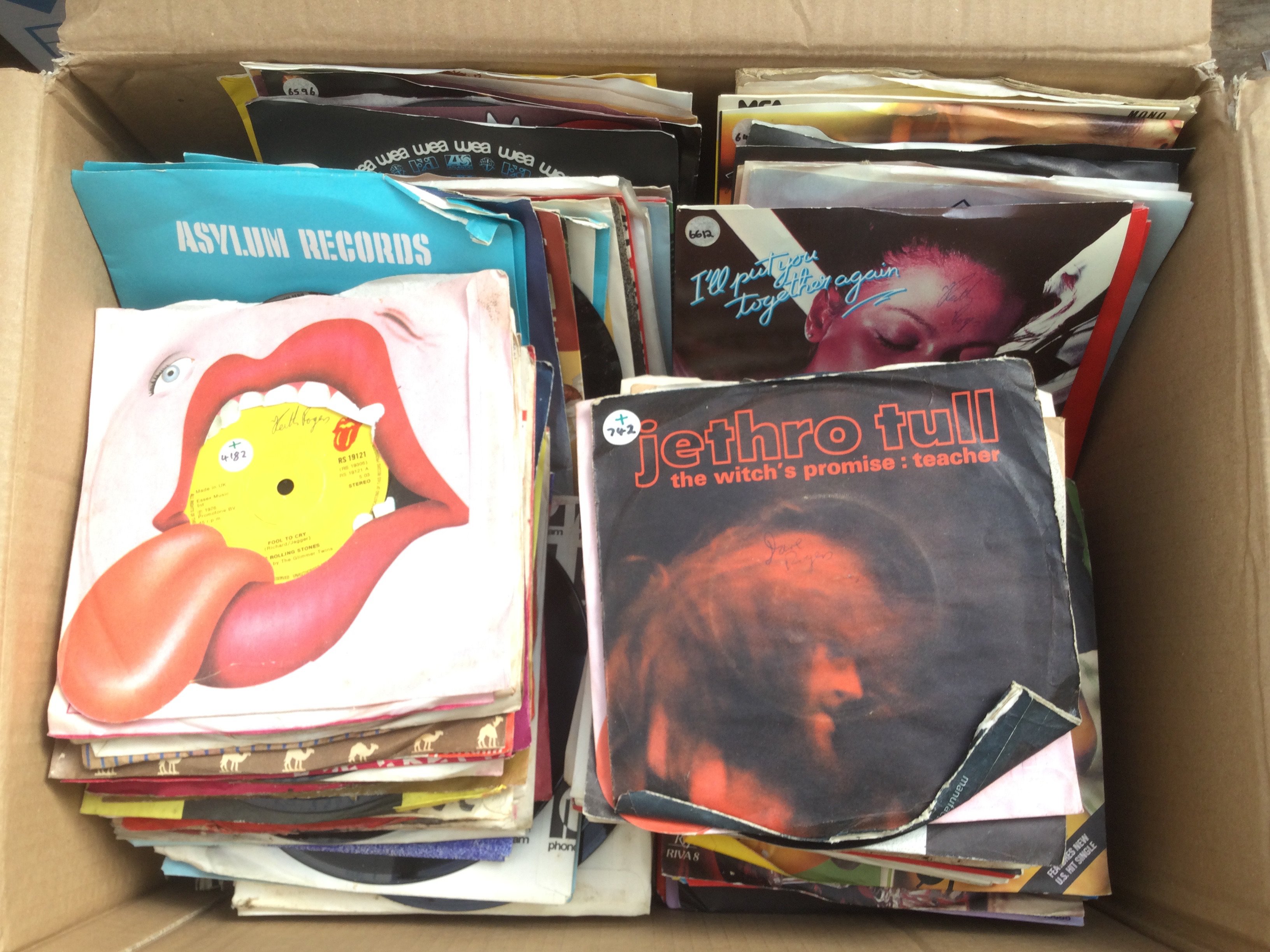 Three boxes of 7" singles and EPs by various artists including Jethro Tull, The Kinks, Bruce Springsteen and many more.