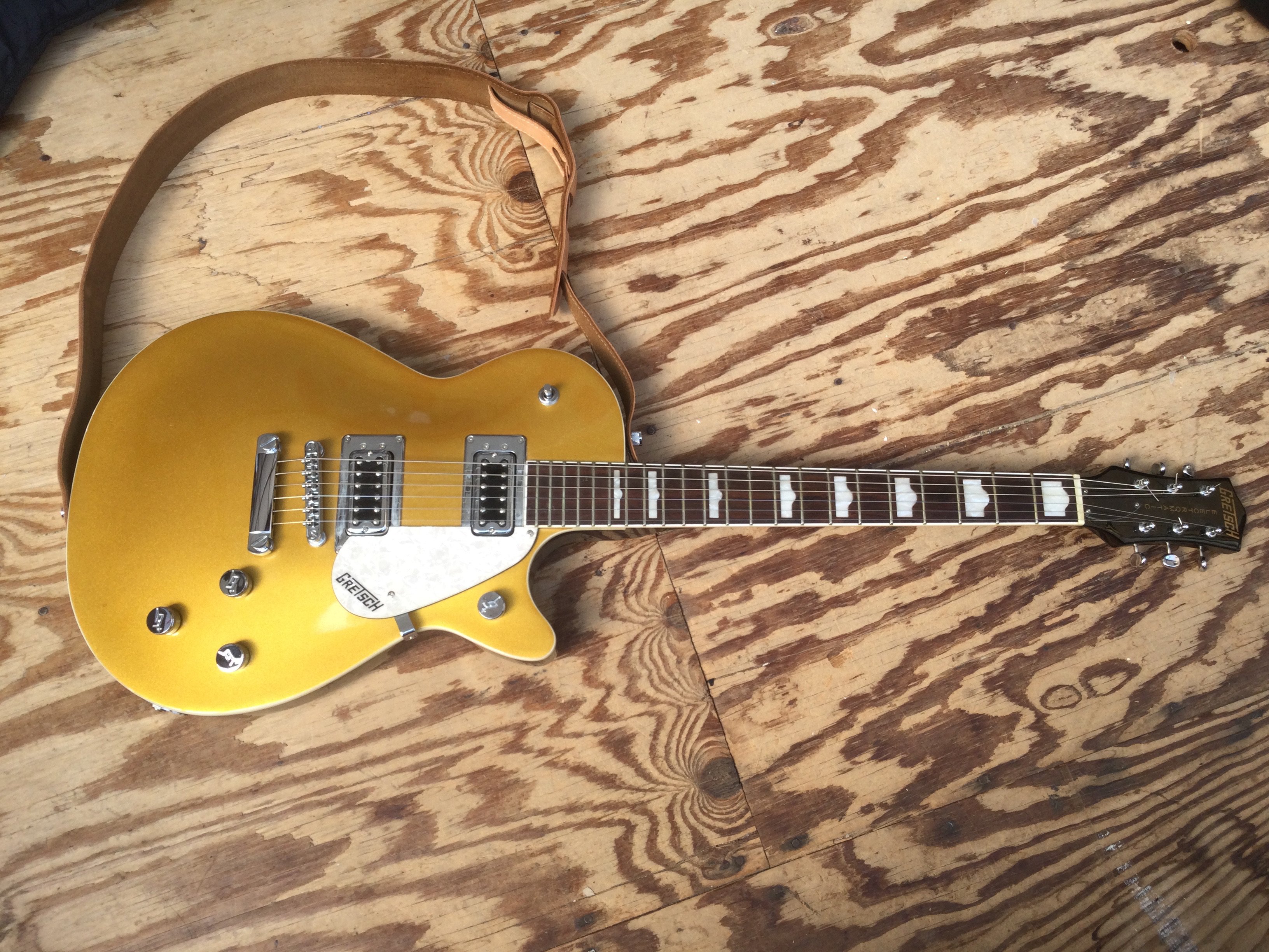A Gretsch G5438 electric guitar in gold sparkle finish. Comes with a soft carry case.