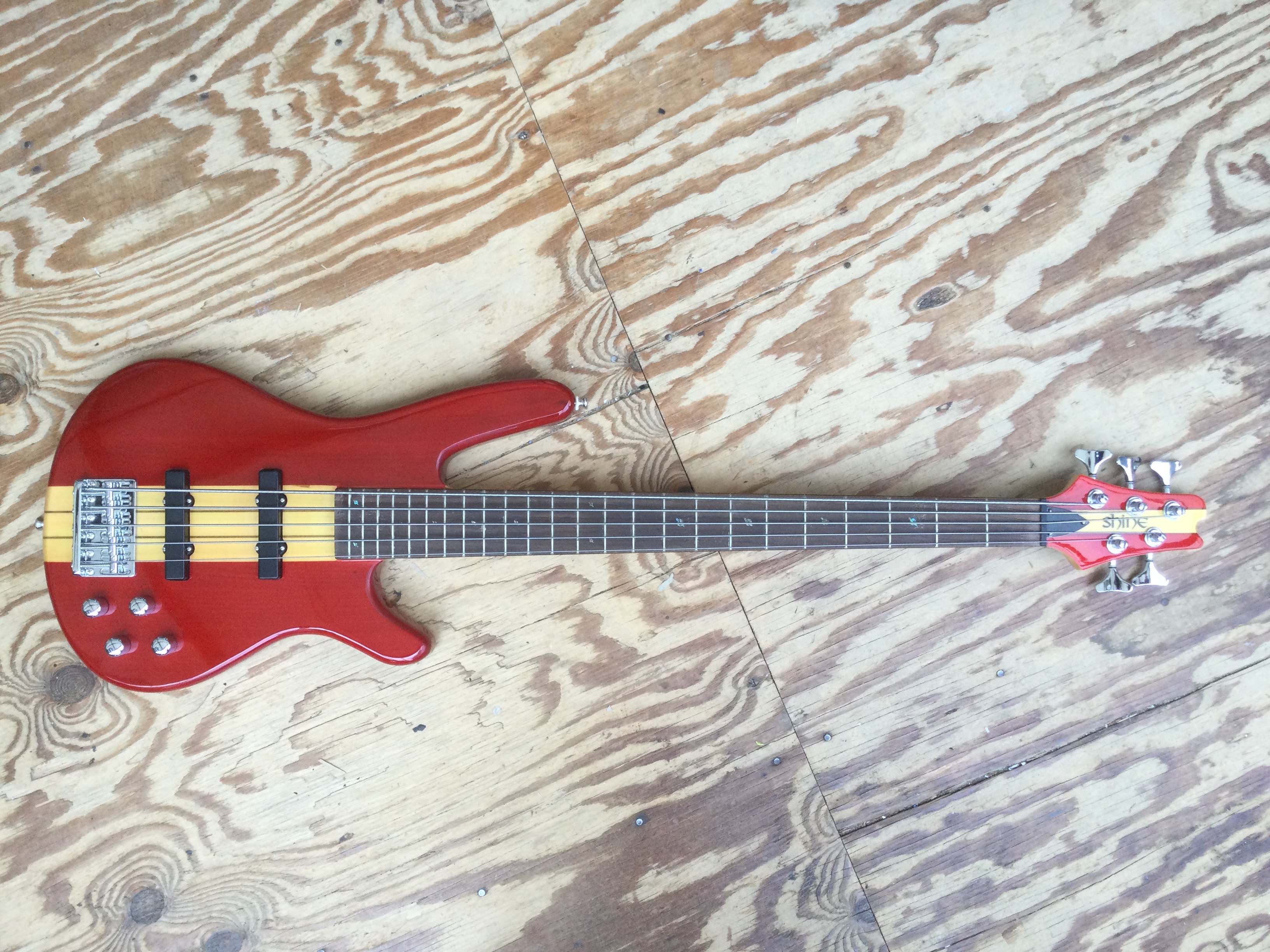 A Shine 5 string bass guitar. Comes with a soft carry case.