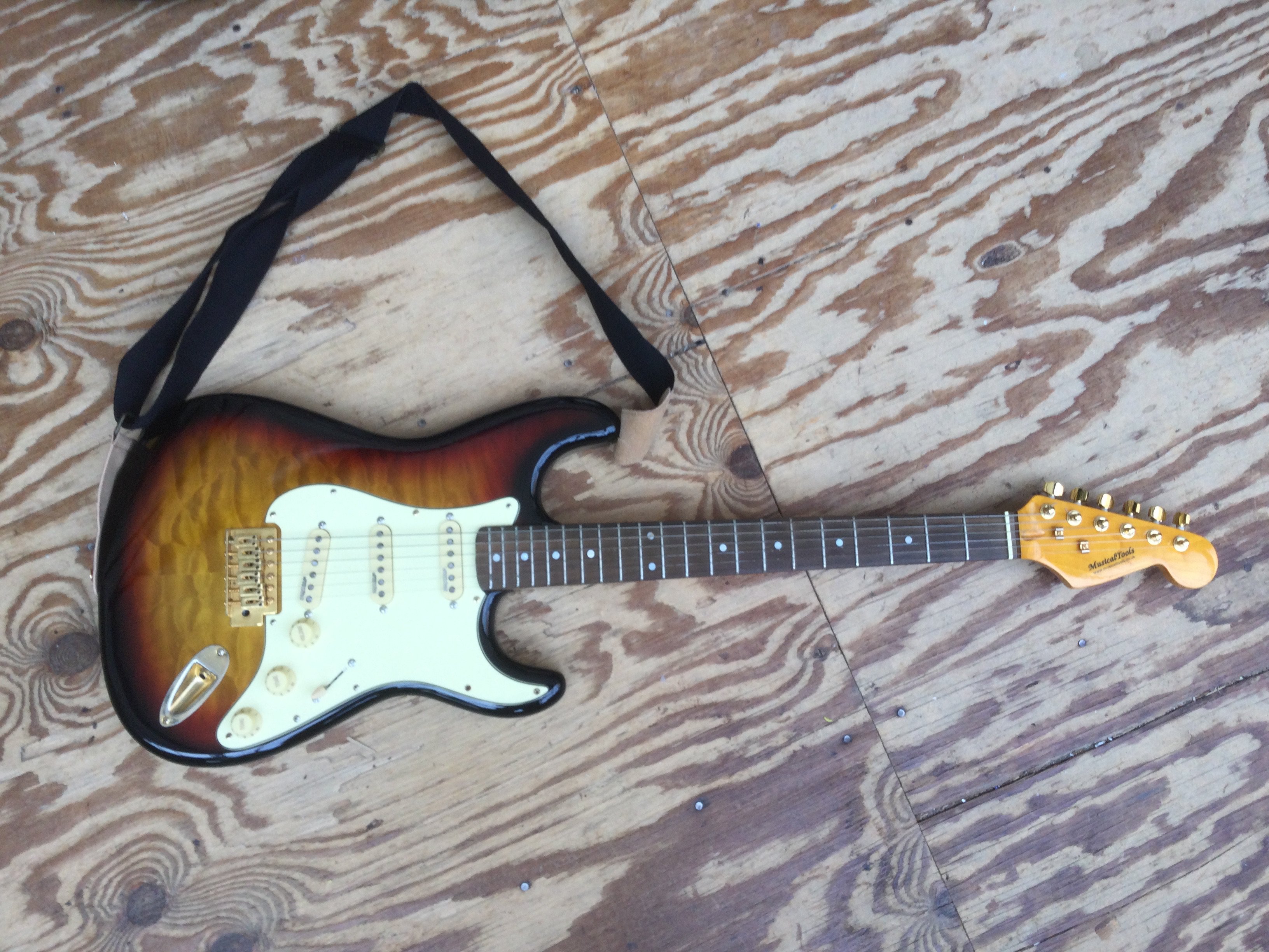 A Musical Tools Stratocaster style electric guitar. Comes with a soft carry case.