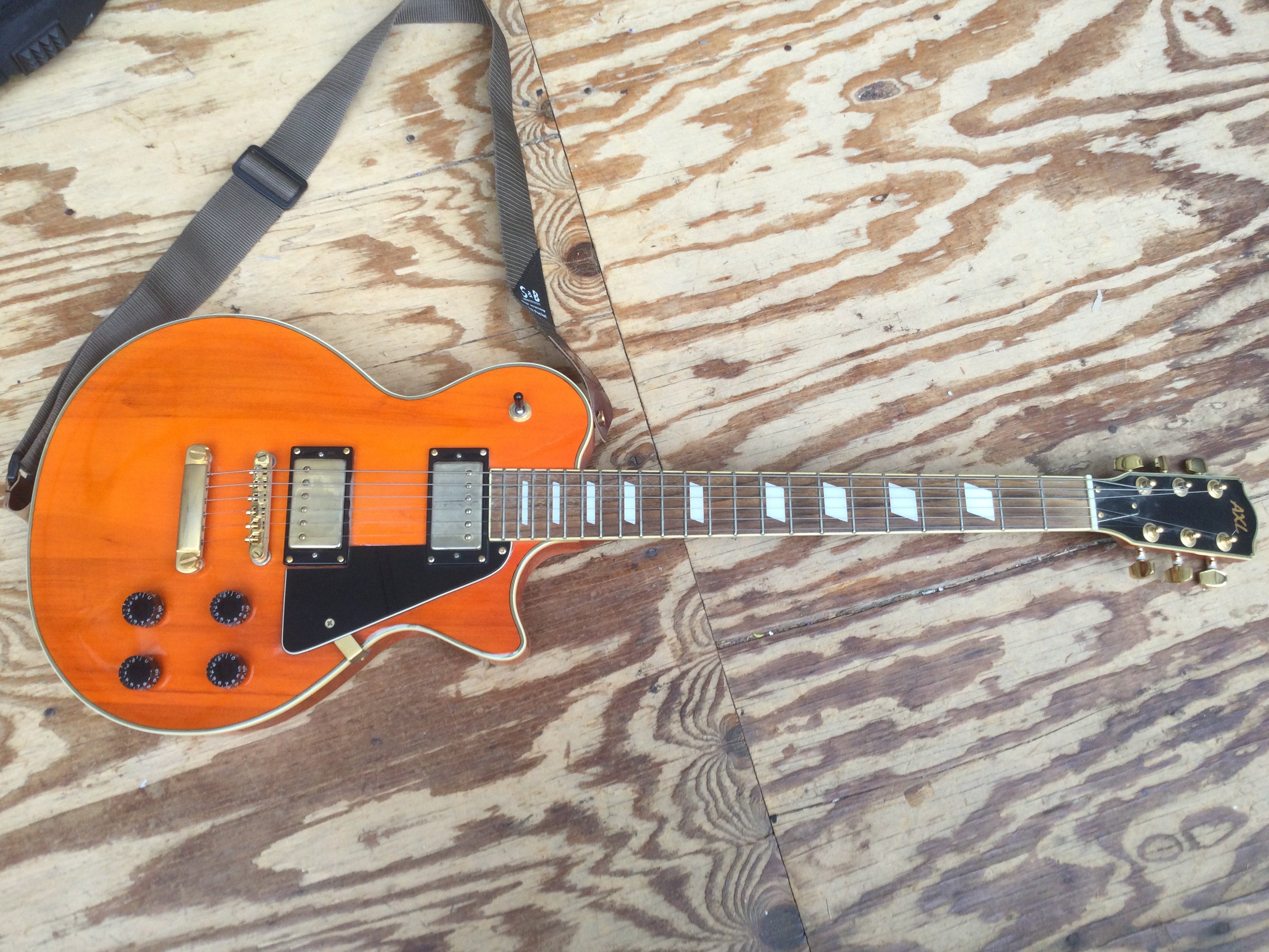 An Axl Les Paul style electric guitar. Comes with a soft carry case.