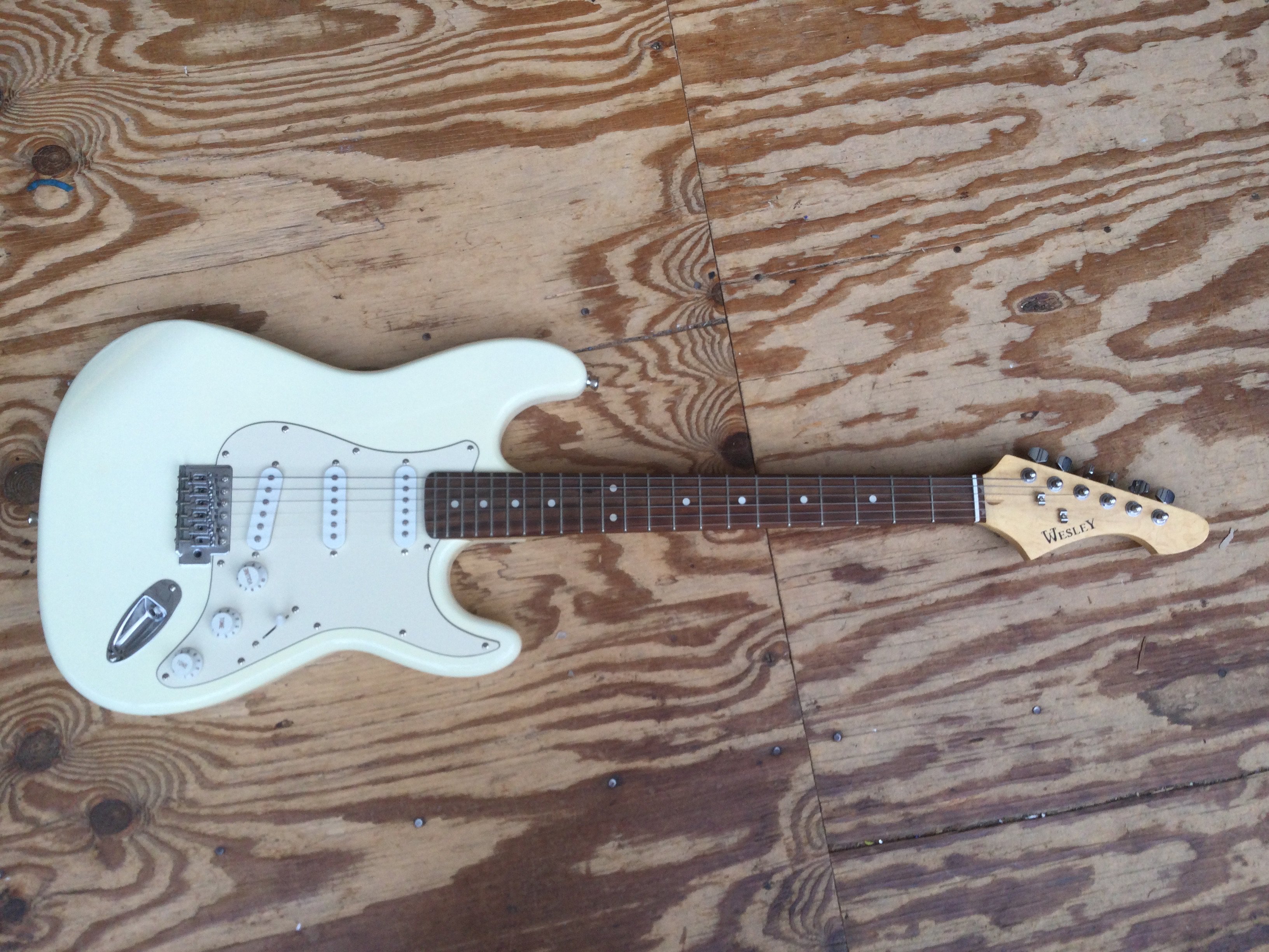 A Wesley Stratocaster style electric guitar. Comes with a soft carry case.