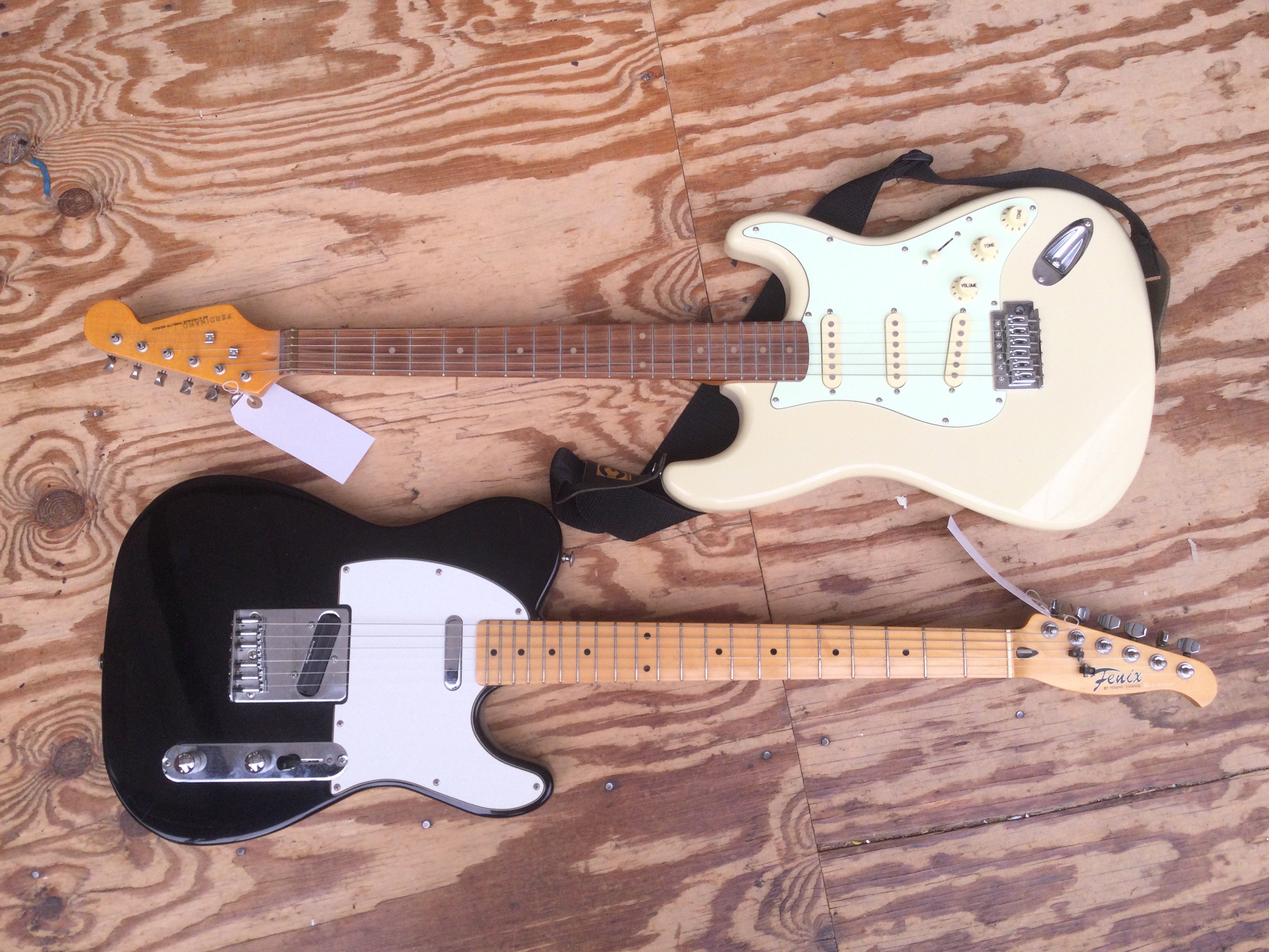 Two electric guitars comprising a Ferdinand Stratocaster style guitar and a Fenix Telecaster style guitar fitted with a Seymour Duncan bridge pickup. No cases.