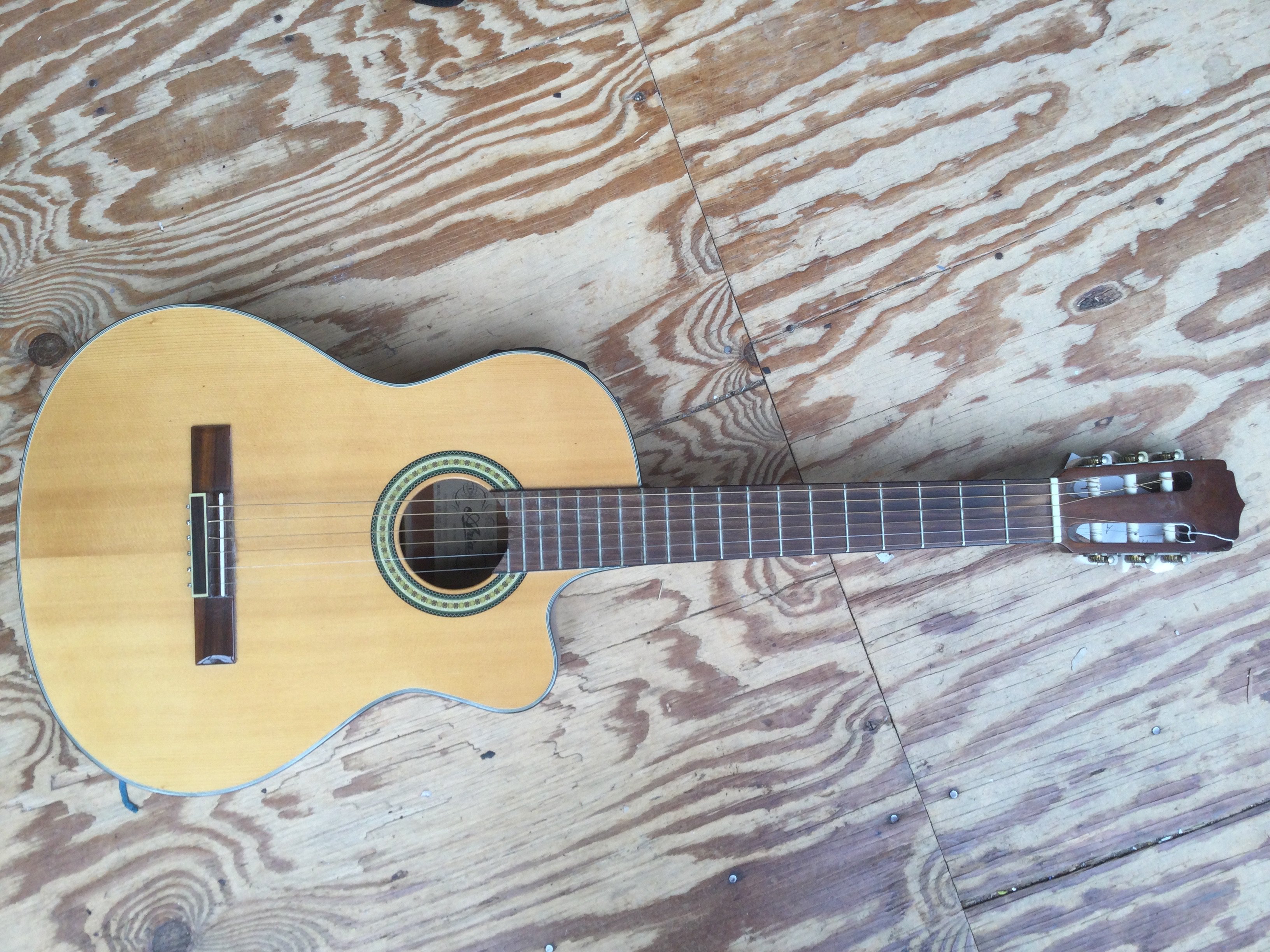 An Aria AK30-CE electro acoustic guitar. No case.