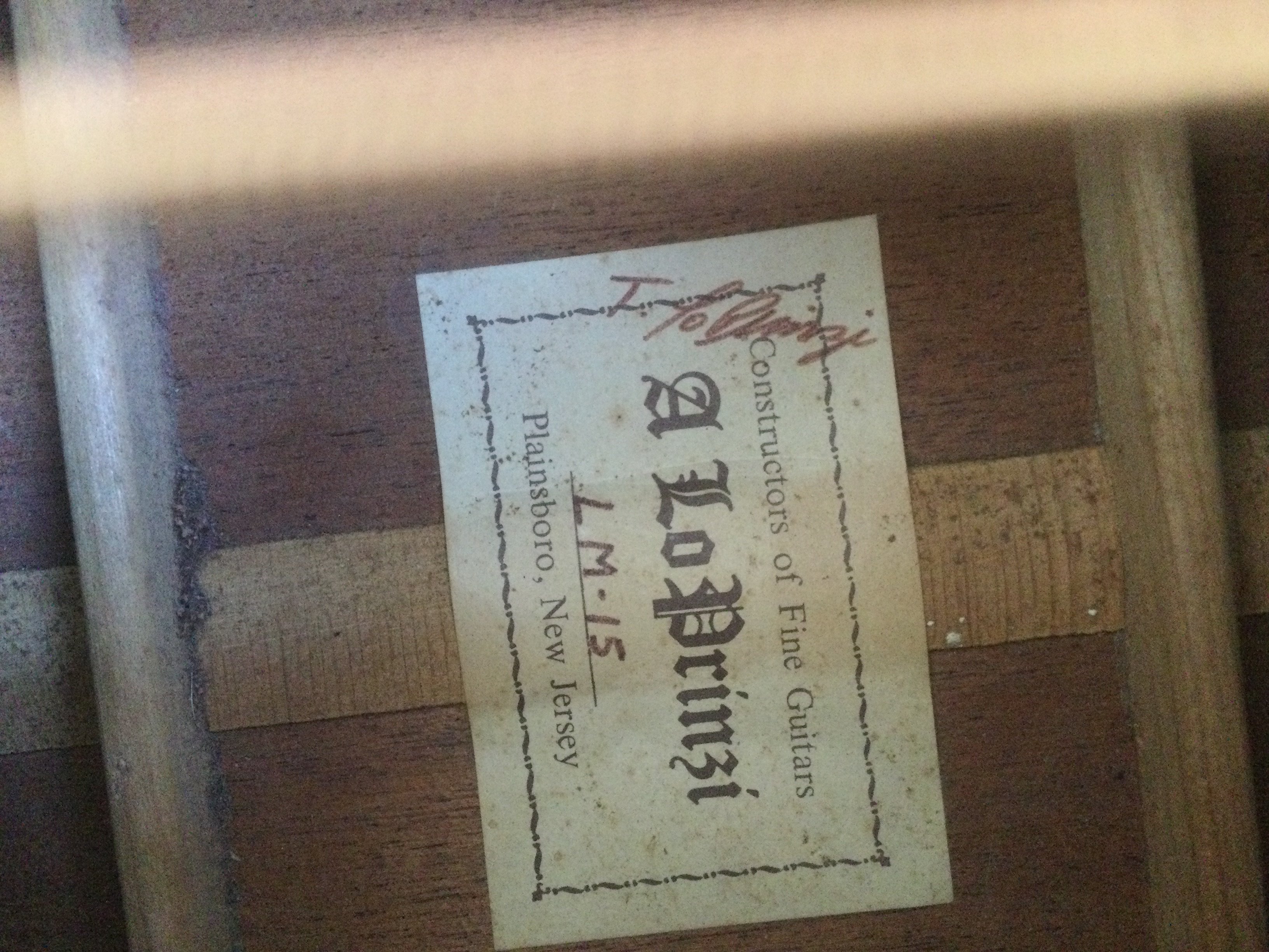 An LM-15 Lo Prinzi hand built acoustic guitar together with one other acoustic guitar. No cases.