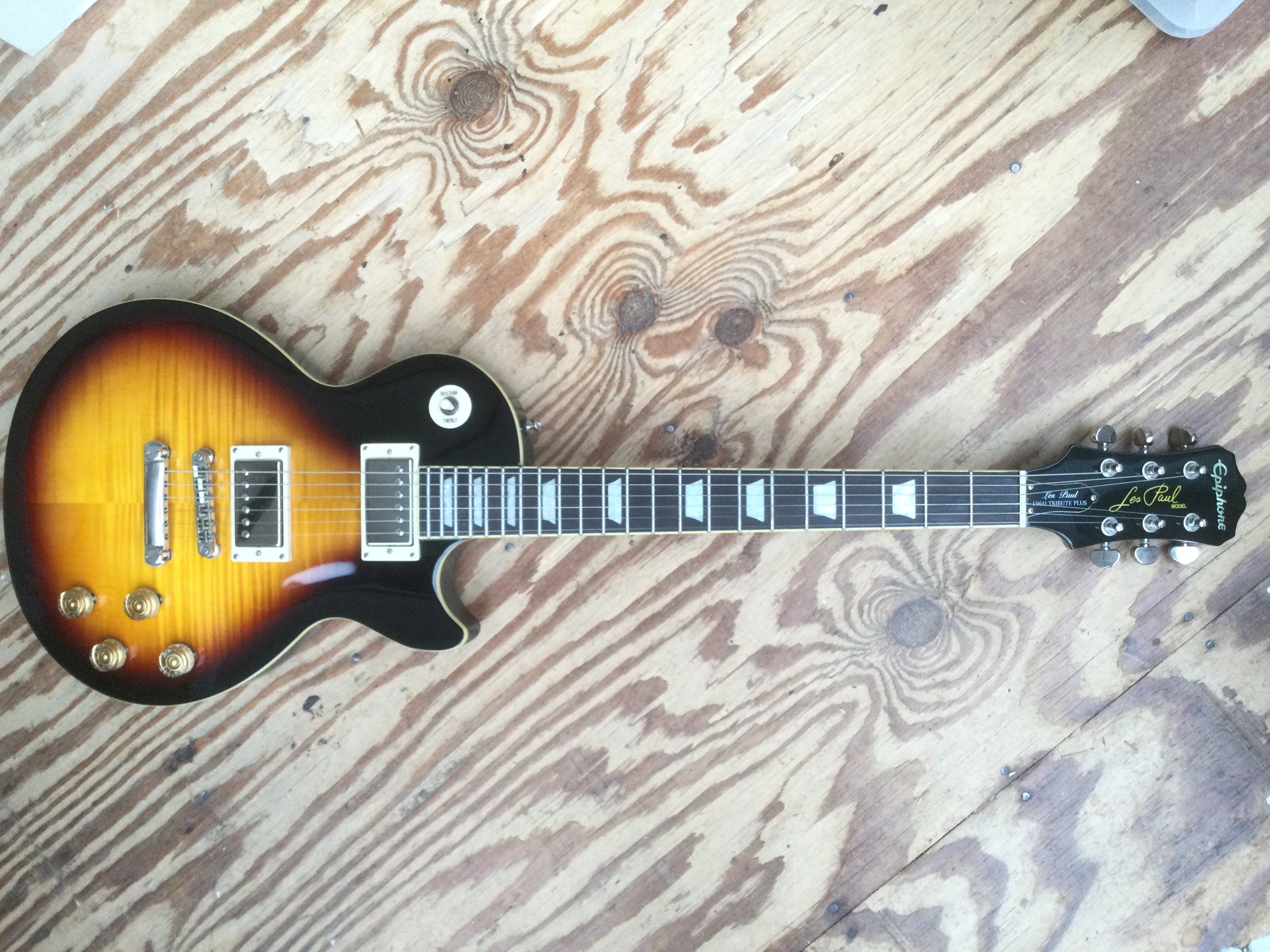 An Epiphone by Gibson Les Paul 1960 Tribute Plus electric guitar. Comes with a soft carry case.