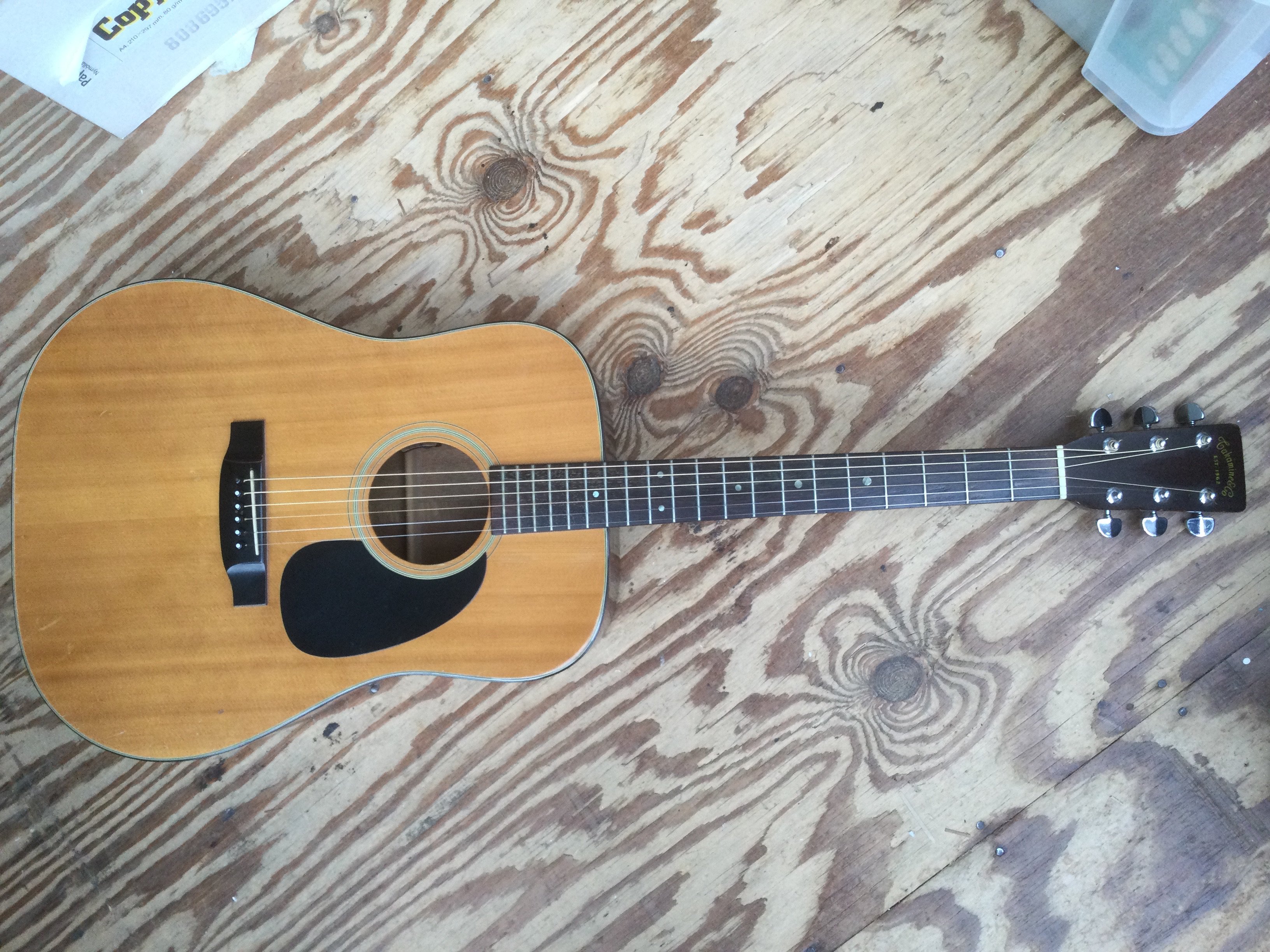 A Takamine acoustic guitar retro fitted with a pickup. Comes with a soft carry case.