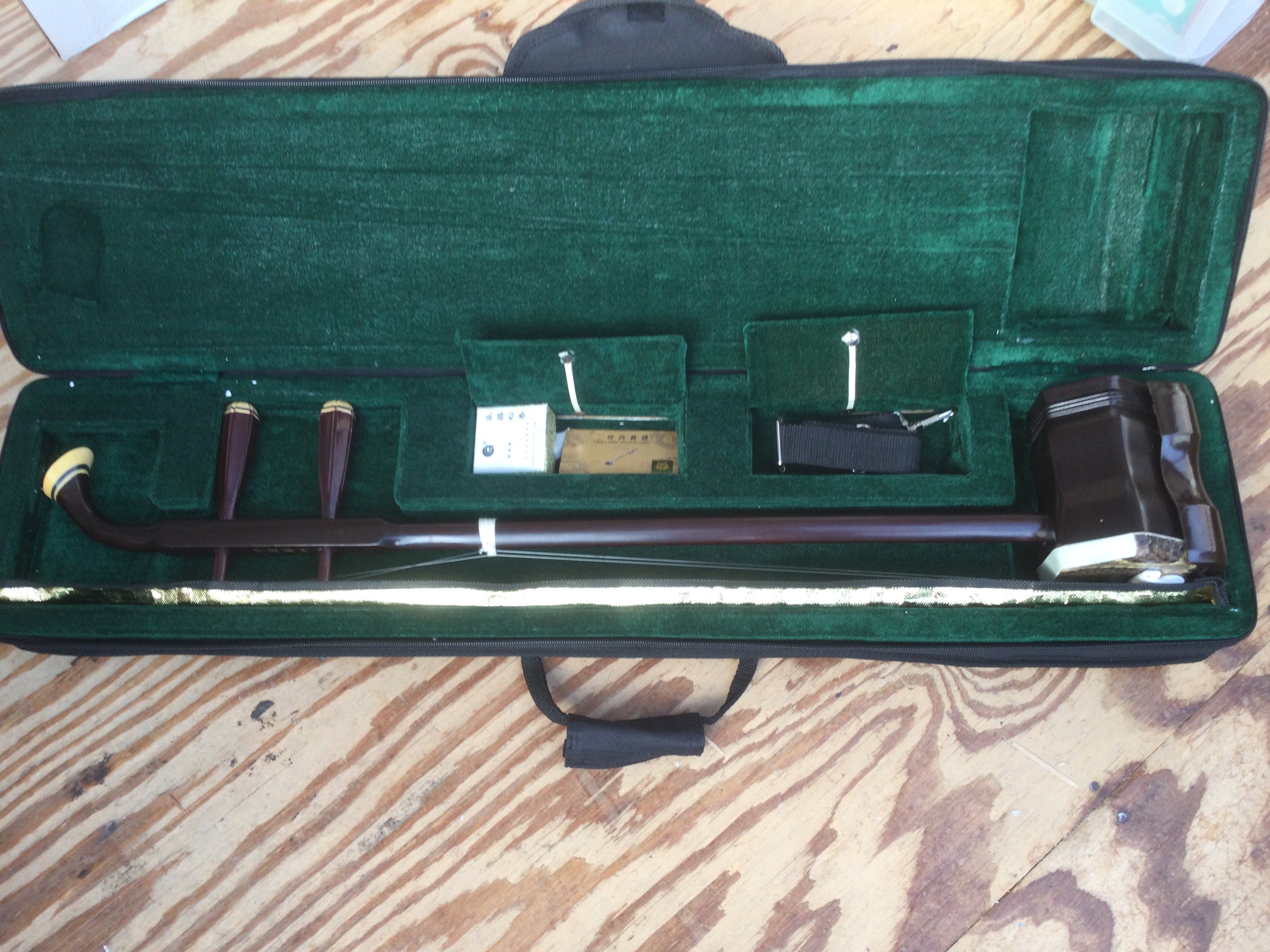 An Erhu, a traditional two stringed Chinese violin, with carry case.
