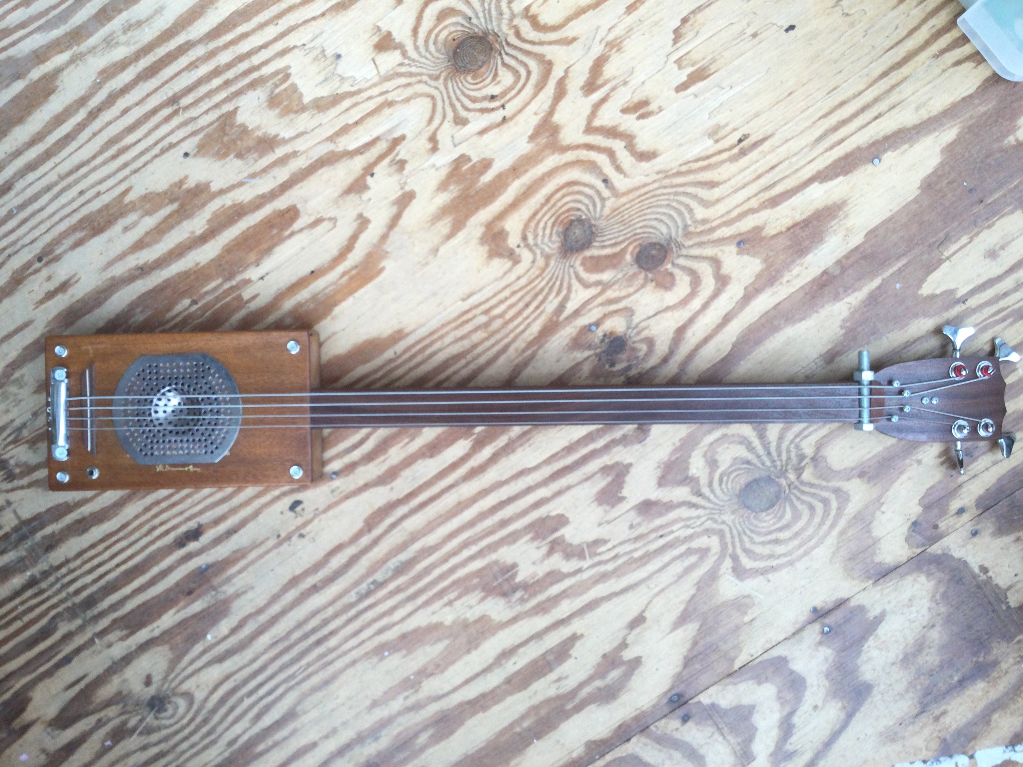 A hand built cigar box bass guitar. No case.
