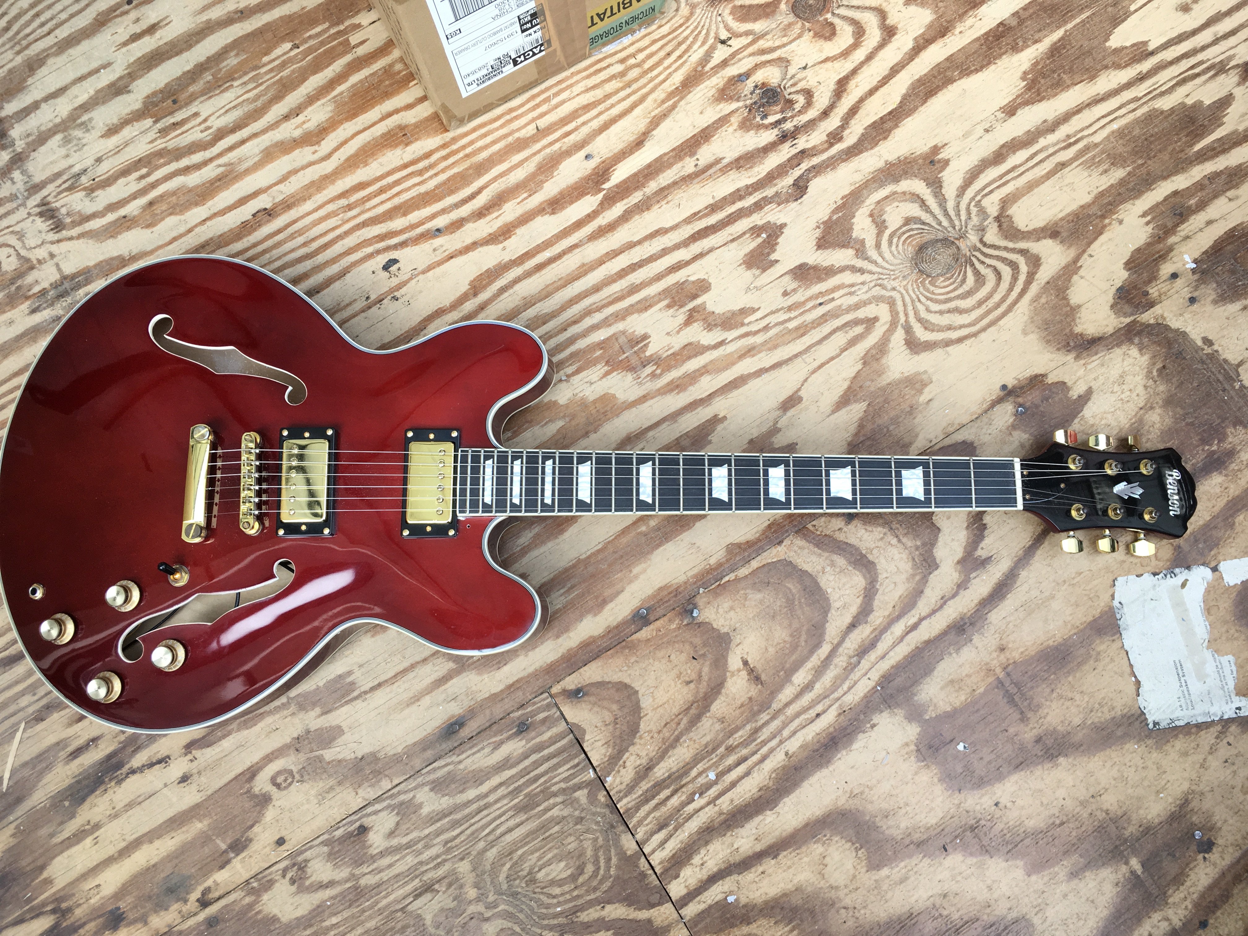 A Benson 335 style electric guitar, no case.