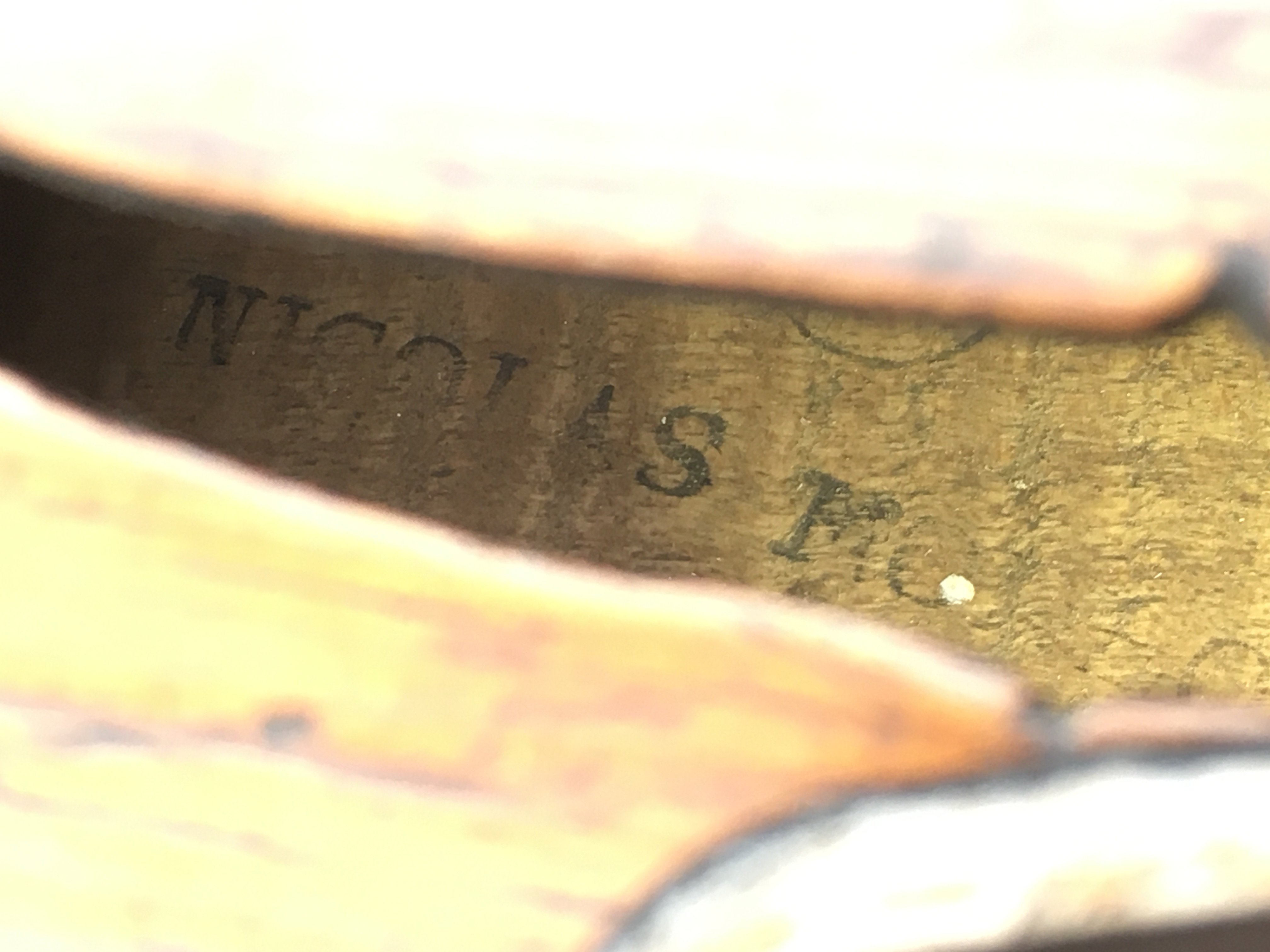 A violin and bow. Maker's name to inside of sound hole almost illegible, please see images. Make of bow is Leon Bernardel, Paris. No case.